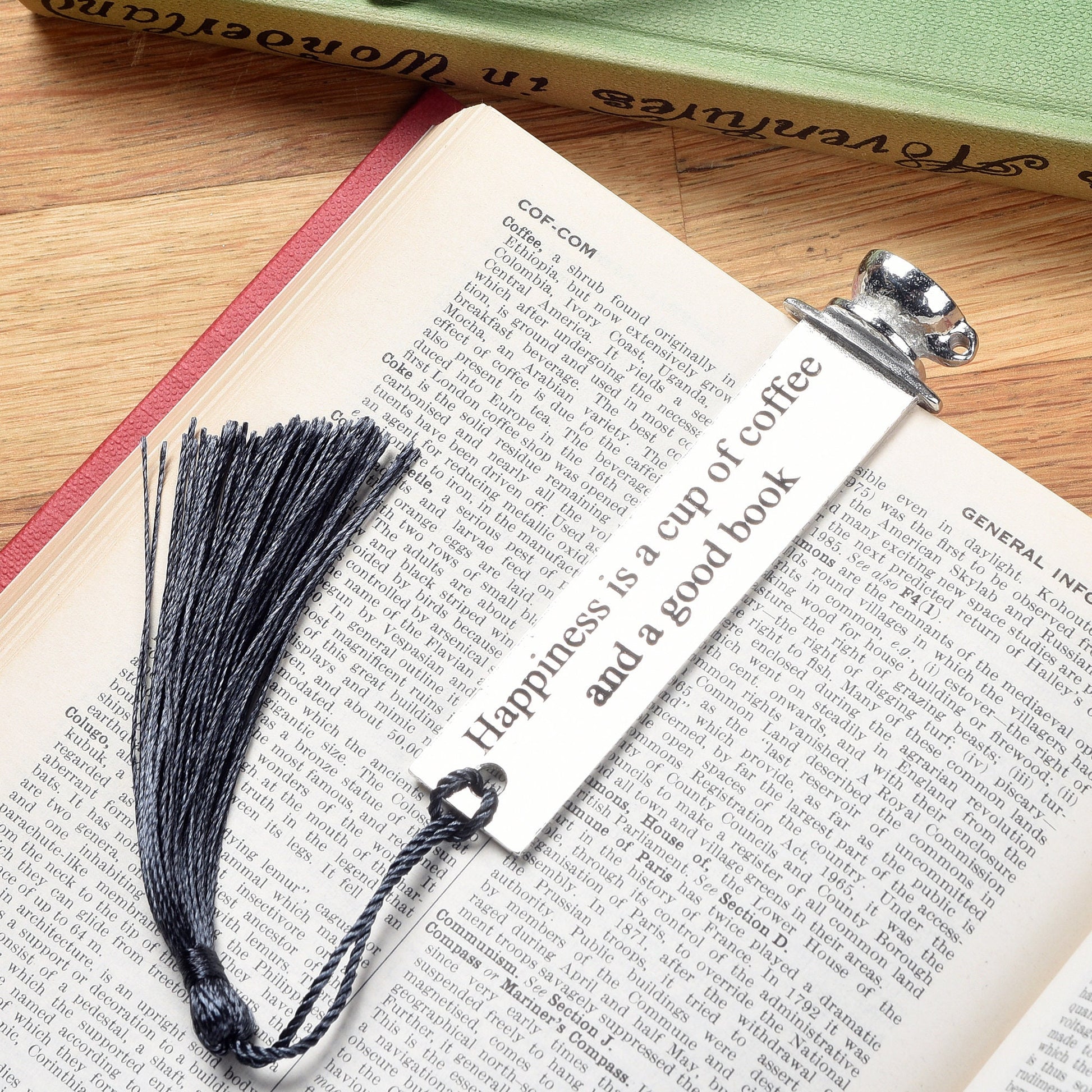 A personalised engraved pewter metal  bookmark with a coffee cup on the top. On the front the quotation 'Happiness is a cup of coffee and a good book'. We engrave the back with your message. Gifts for coffee lovers, book lovers gifts.