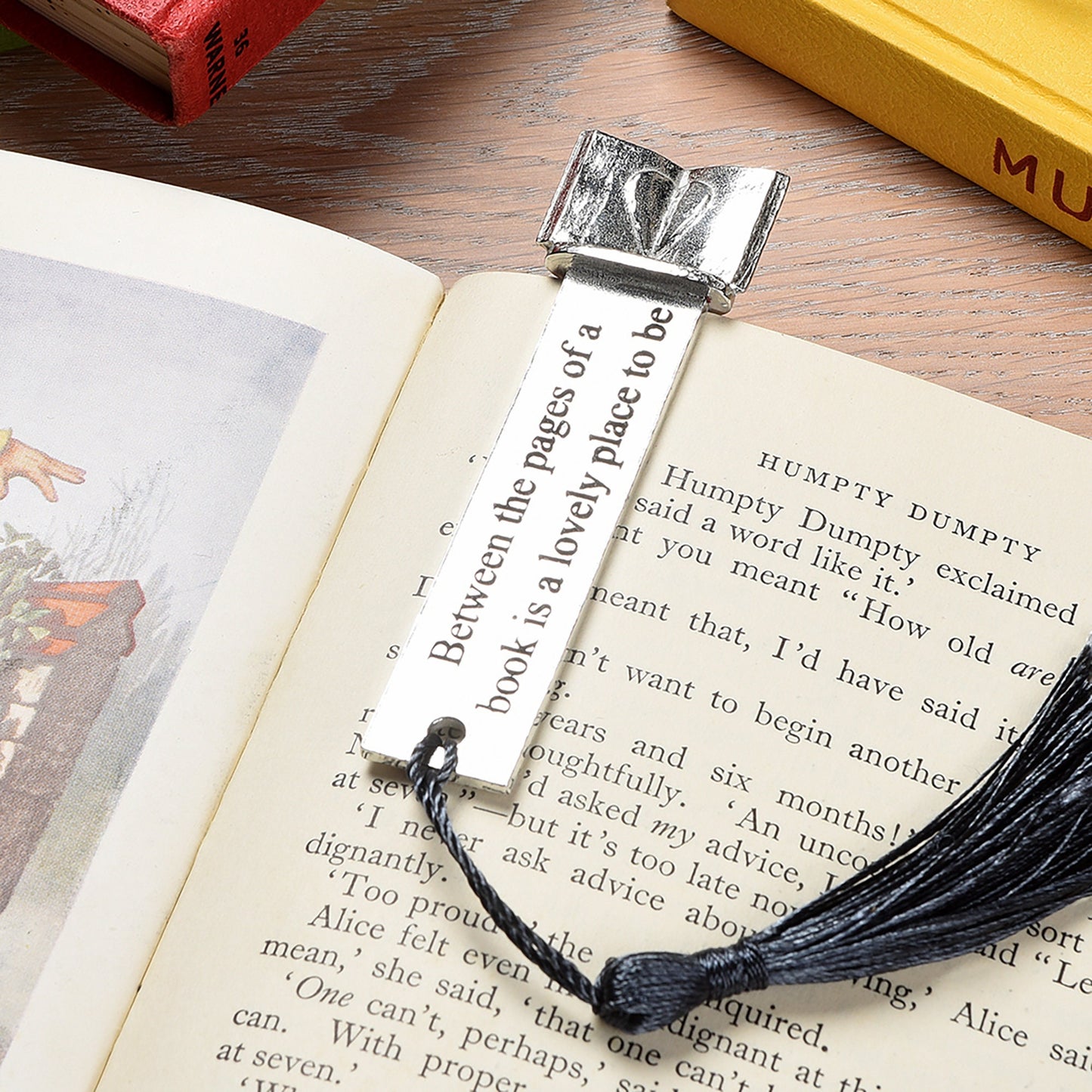 A personalised engraved pewter metal  bookmark with a heart on an open book on the top. On the front the quotation 'Between the pages of a book is a lovely place to be'. Gifts for book lovers, book gifts, bookmarks for books