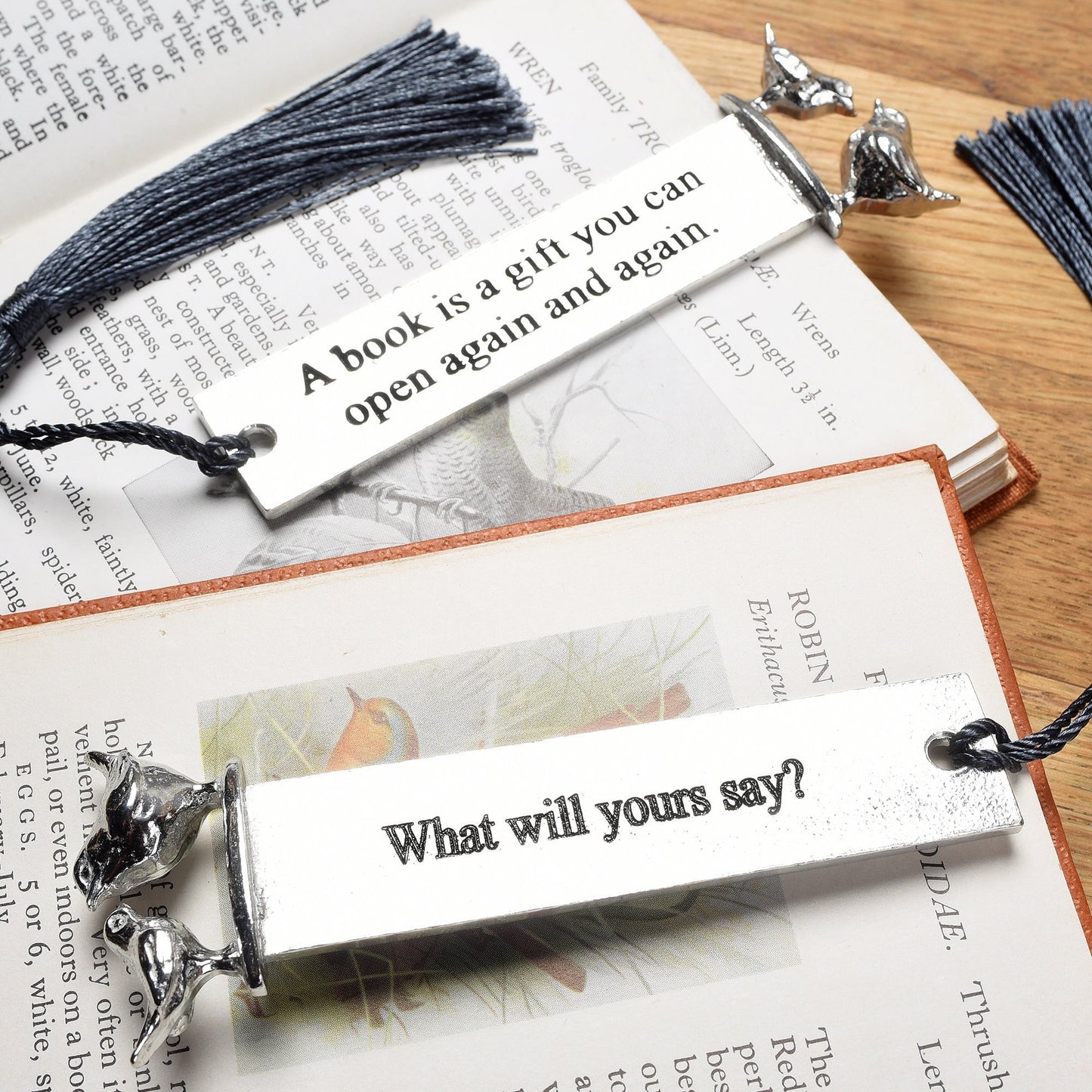 A personalised engraved pewter metal  bookmark with a wren and a robin on the top. On the front the quotation 'A book is a gift you can give again and again'. We engrave the back with your message. Gifts for book lovers, bird lovers