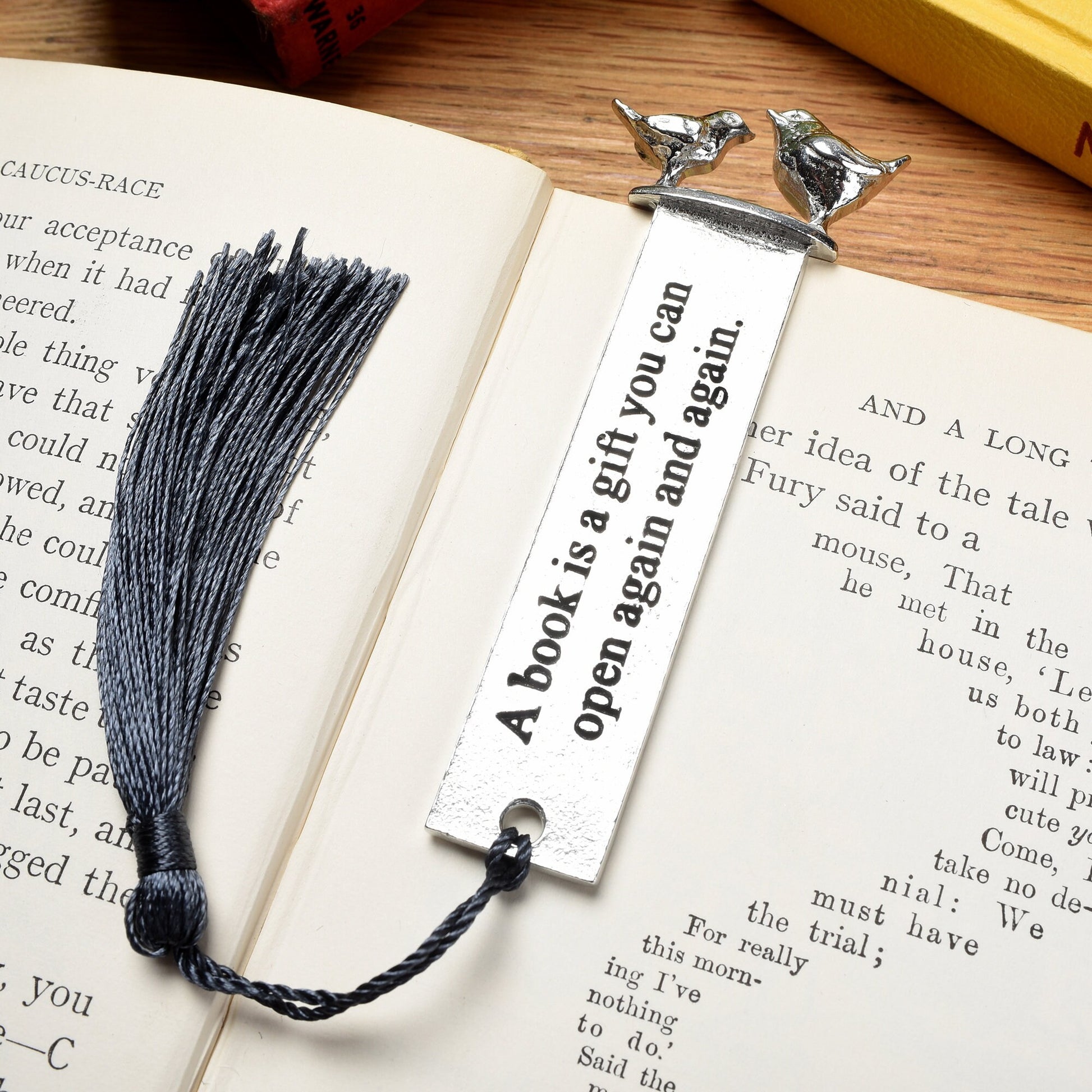 A personalised engraved pewter metal  bookmark with a wren and a robin on the top. On the front the quotation 'A book is a gift you can give again and again'. We engrave the back with your message. Gifts for book lovers, bird lovers