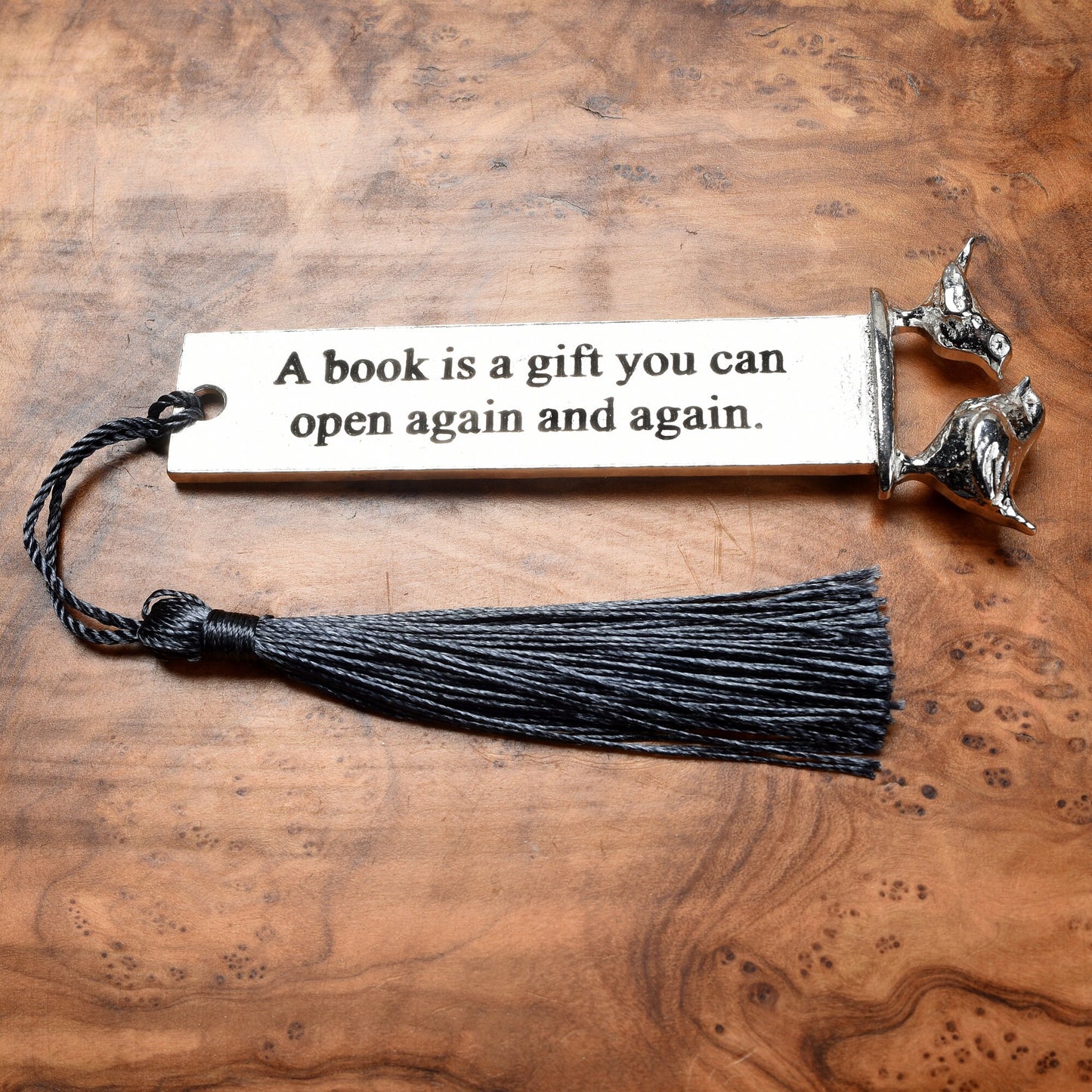 A personalised engraved pewter metal  bookmark with a wren and a robin on the top. On the front the quotation 'A book is a gift you can give again and again'. We engrave the back with your message. Gifts for book lovers, bird lovers