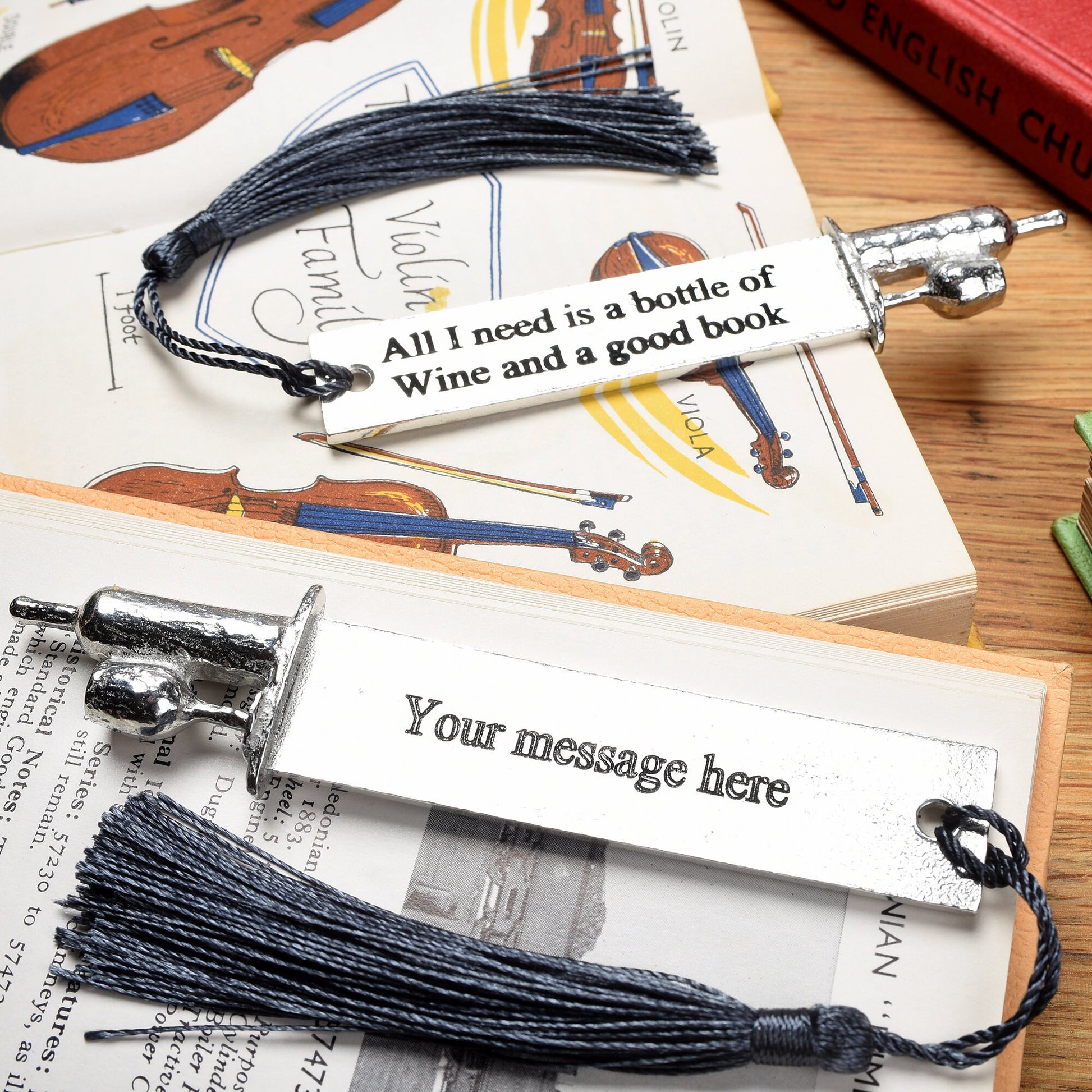 A personalised engraved pewter metal  bookmark with a wine bottle and glass on the top. On the front the quotation 'All I need is a bottle of wine and a good book'. We engrave the back with your message. Gifts for wine lovers, book lovers gifts.