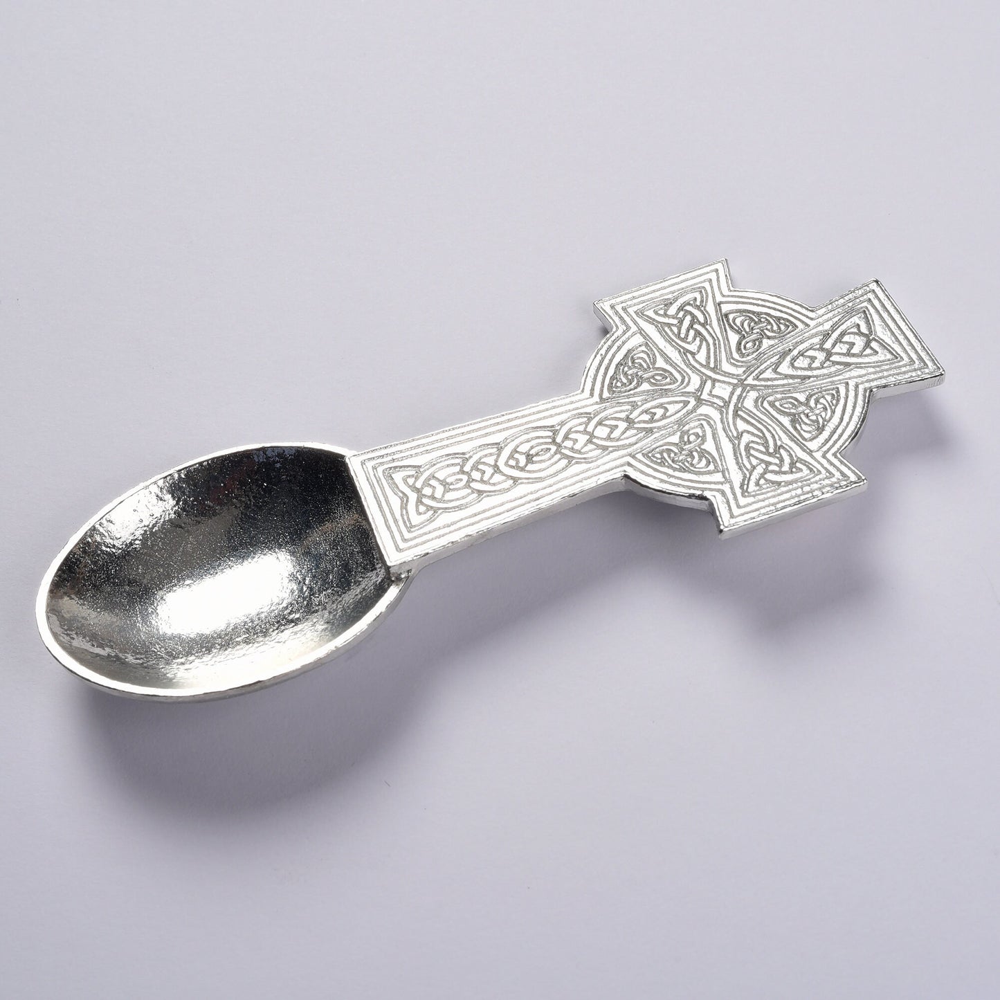 A Celtic cross designed Christening spoon with the words On Your Christening on the back. We engrave your message on the central panel. Christening gifts for boys and girls. UK handmade