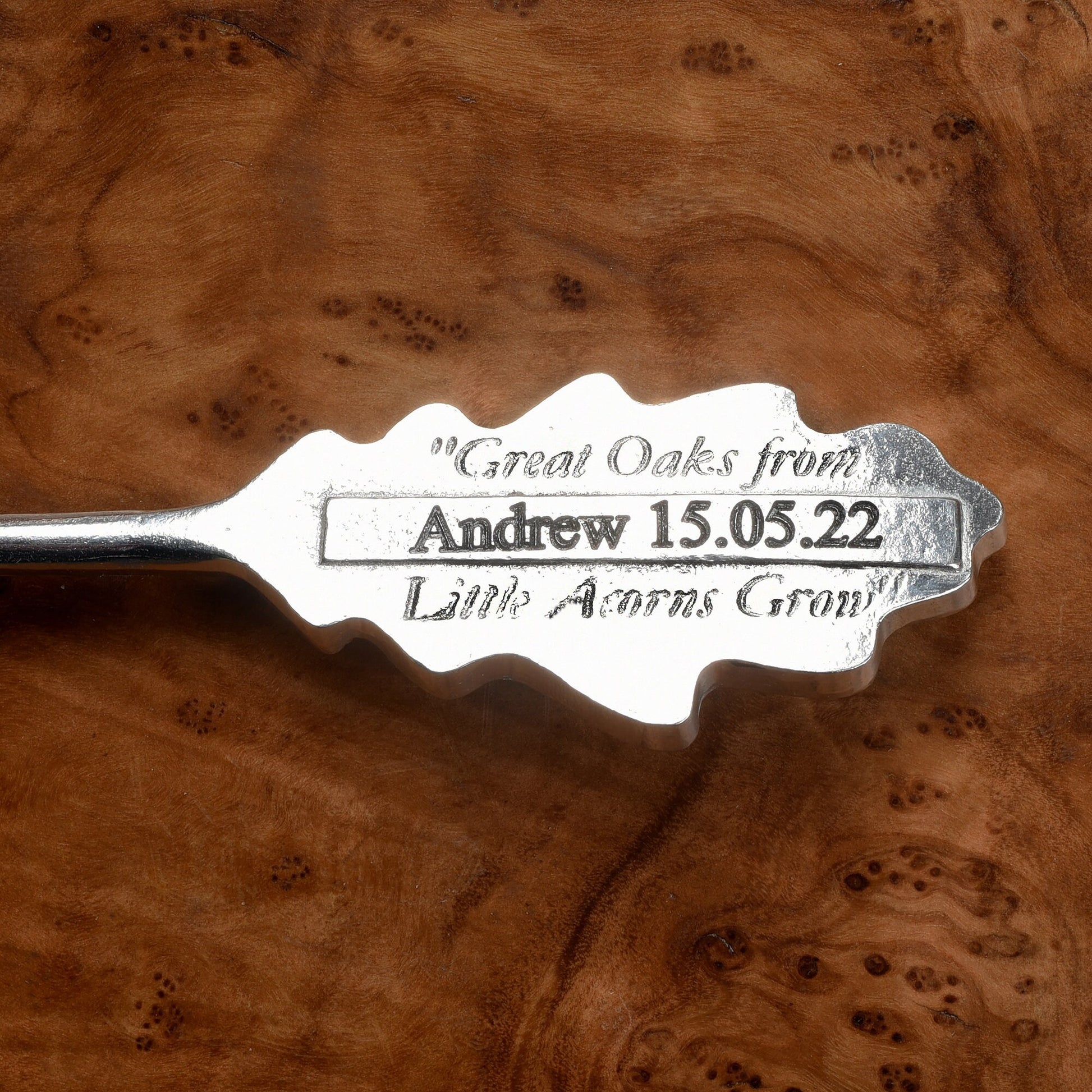 A personalised, engraved pewter oak leaf topped spoon. 'Great oaks from little acorns grow' is written on the back with a space where we engrave your message. Christening gifts for boys and girls