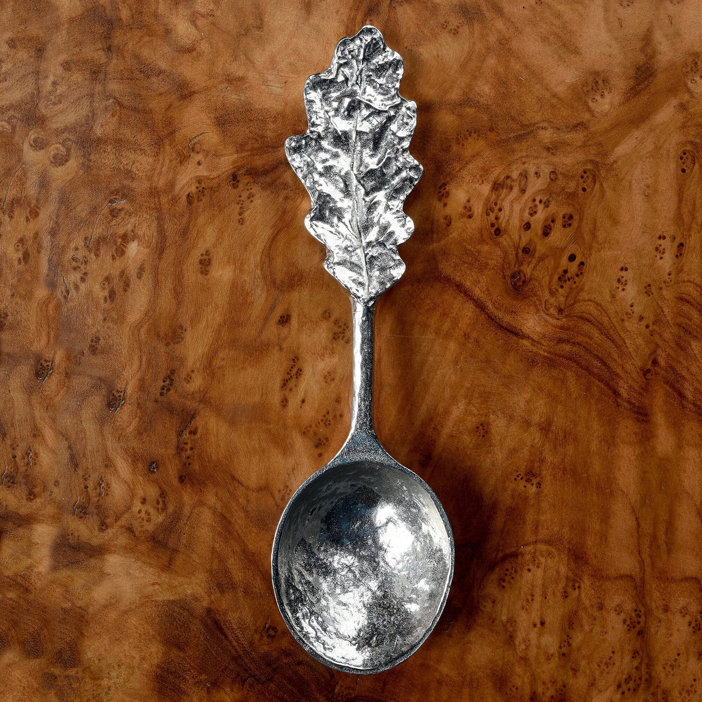 A personalised, engraved pewter oak leaf topped spoon. 'Great oaks from little acorns grow' is written on the back with a space where we engrave your message. Christening gifts for boys and girls