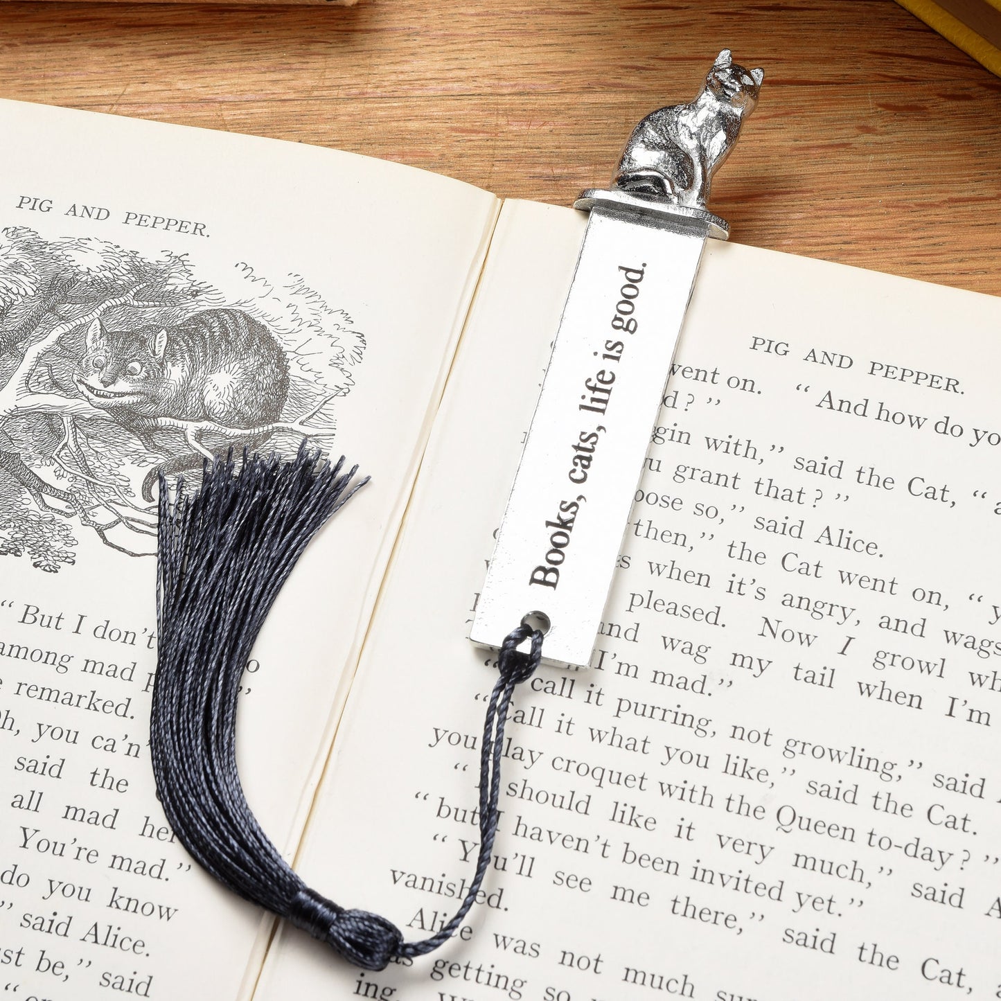 A personalized engraved pewter metal  bookmark with a cat sculpture on the top. On the front the quotation 'Books, cats, life is good'. We engrave the back with your message. Gifts for cat lovers, book lovers gifts, cat gifts.