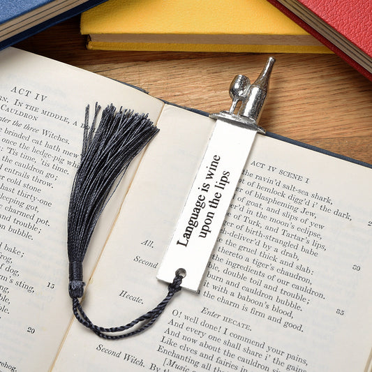 A personalised engraved pewter metal  bookmark with a wine bottle and glass on the top. On the front the quotation 'Language is wine upon the lips'. We engrave the back with your message. Gifts for wine lovers, book lovers gifts.