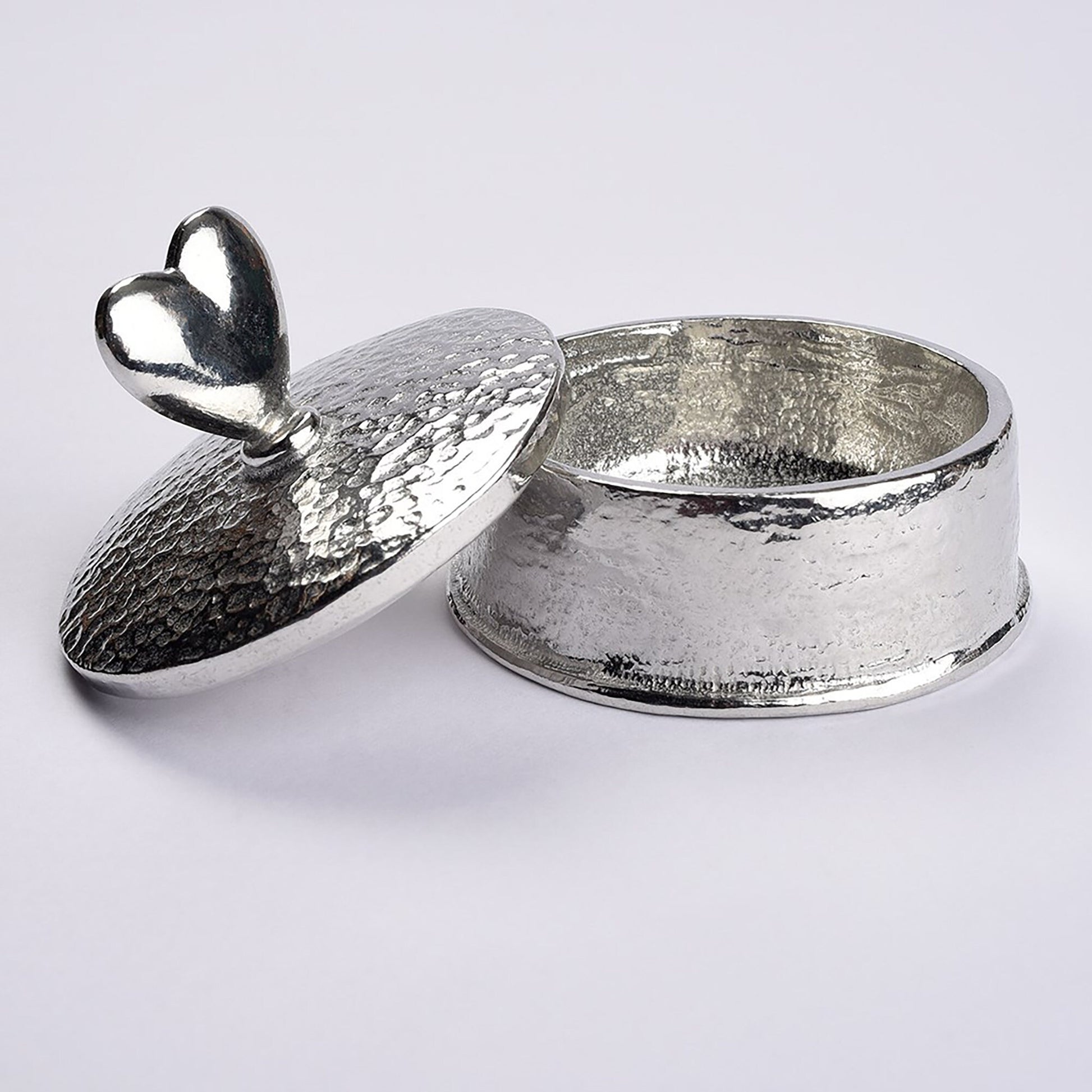 Heart 10th wedding anniversary pewter personalised trinket box gift. Our round anniversary keepsake box features a heart sculpture as a handle. The underside of the lid can be engraved with your message. A perfect tin ten year  anniversary gift (Our pewter is 95% tin)