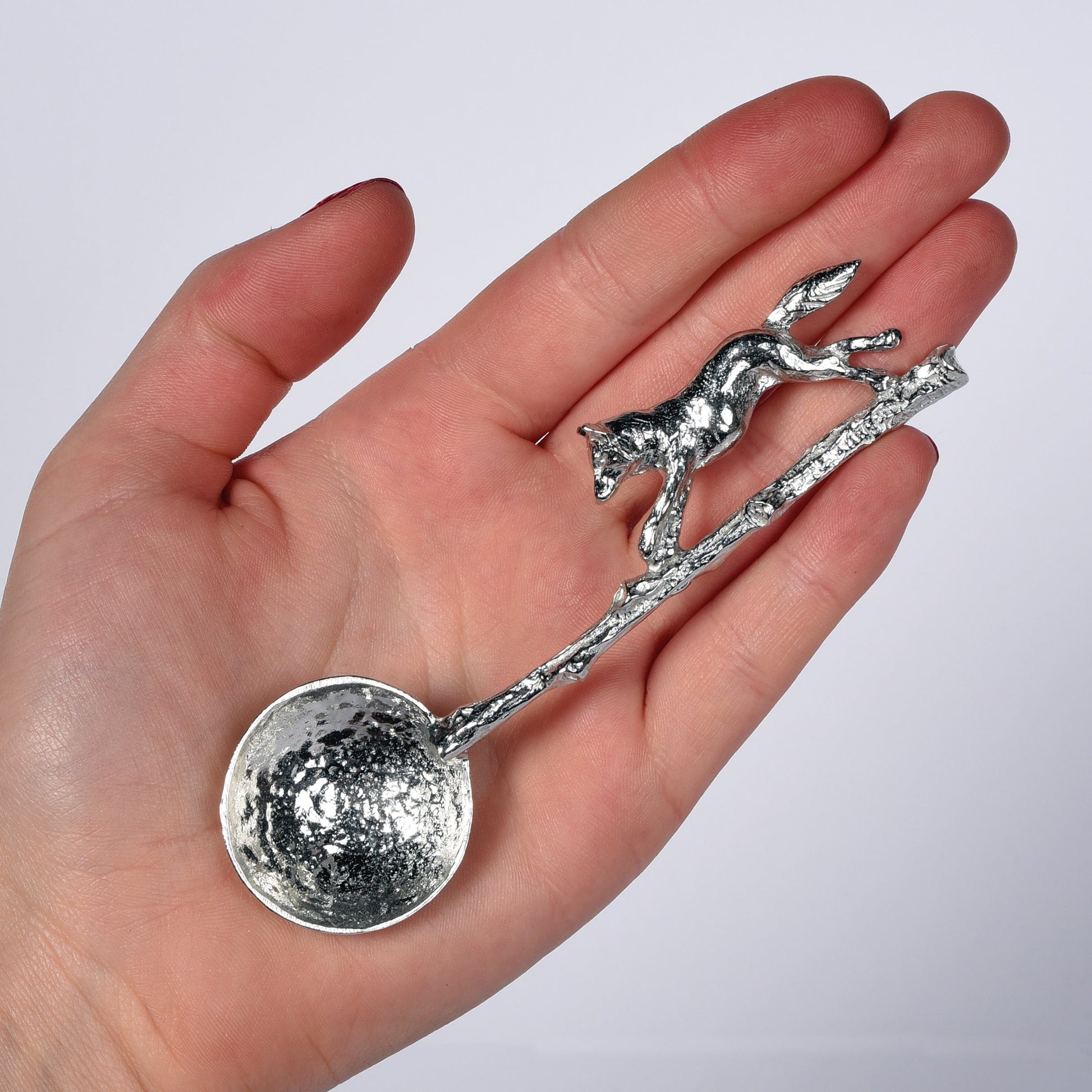 A small spoon pewter sugar spoon with a detailed fox running along a twig handle. Unusual, useful and tactile gifts for nature lovers, fox gifts handmade in the UK useful countryside gifts