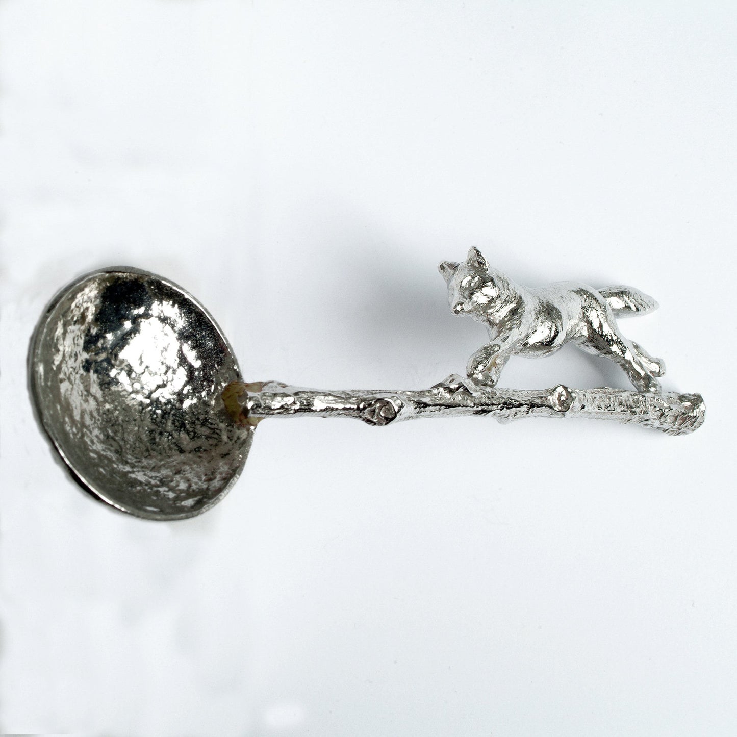 A small spoon pewter sugar spoon with a detailed fox running along a twig handle. Unusual, useful and tactile gifts for nature lovers, fox gifts handmade in the UK useful countryside gifts