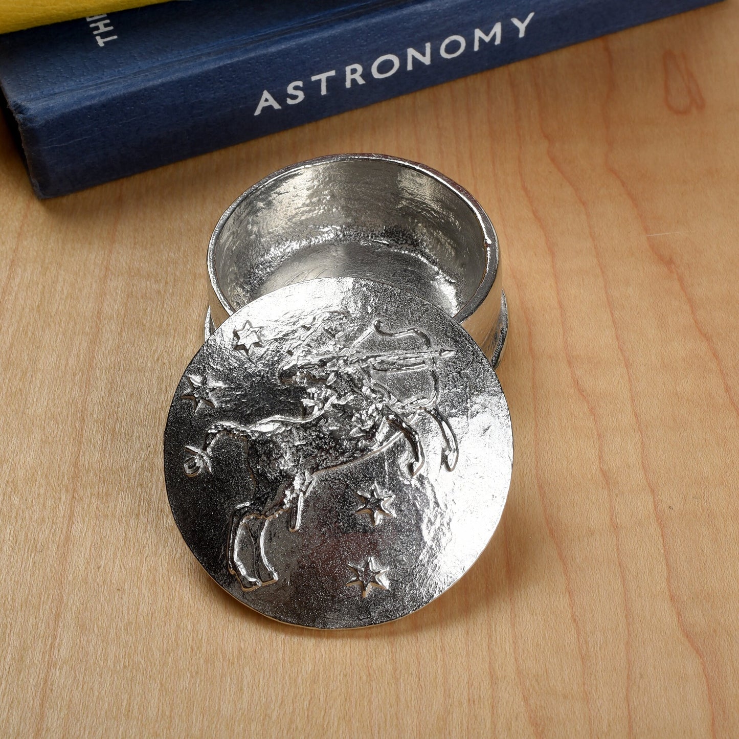 A beautifully detailed and textured Sagittarius zodiac sign guards precious treasure on this lovely personalised pewter trinket box. The underside of the lid can be engraved with your personalised message. Birthday gifts for Sagittarians