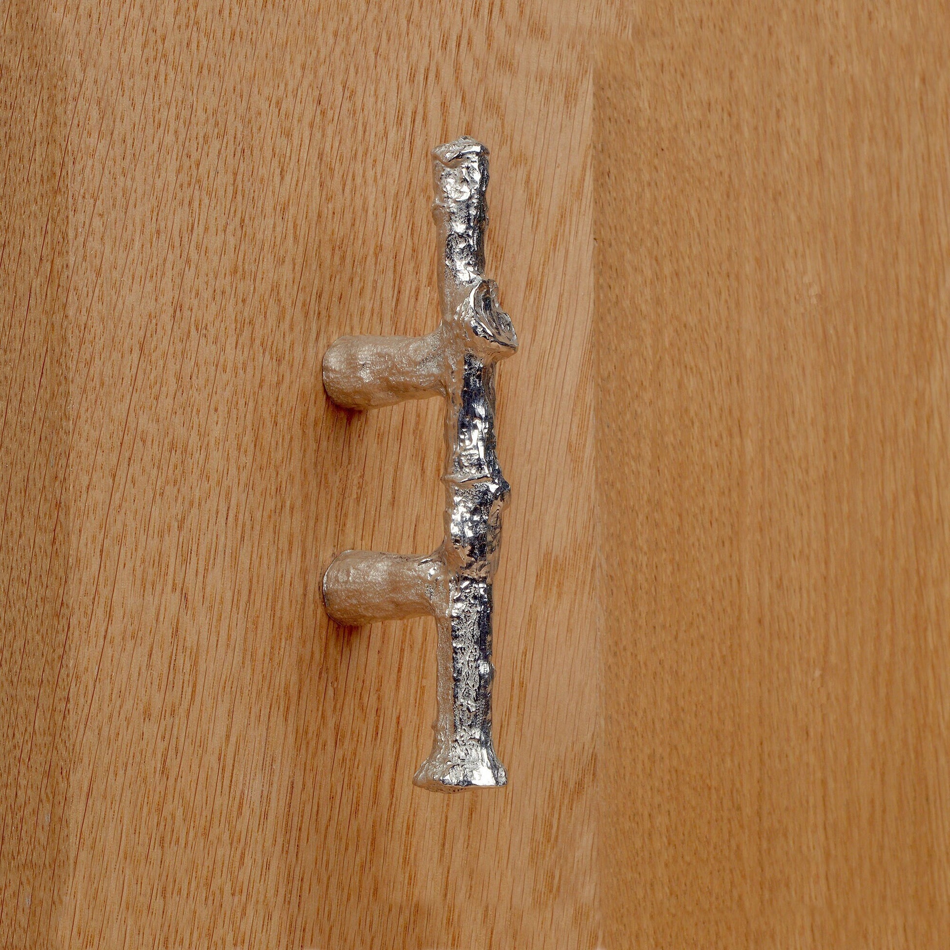 A solid pewter cabinet handle, cupboard knob, furniture handle or drawer pull in the shape of a detailed oak branch or twig. 32 mm between hole centres. Organic, unusual handles UK handmade with finesse