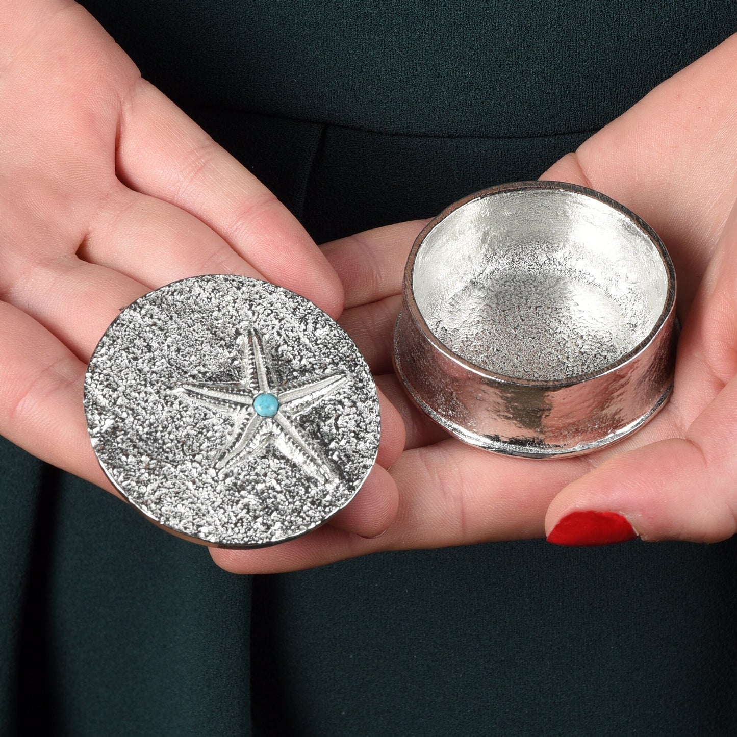 A round  pewter trinket box with a starfish on the lid. A turquoise stone sits on the meeting point of the 5 legs. Nautical gifts for lovers of the seaside and sea life.