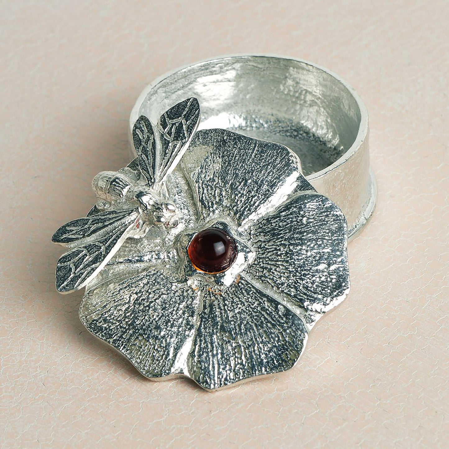 A forget me not flower pewter keepsake trinket box with an amber stone in the middle with a bee sculpture. Bee gifts, gifts for bee lovers.