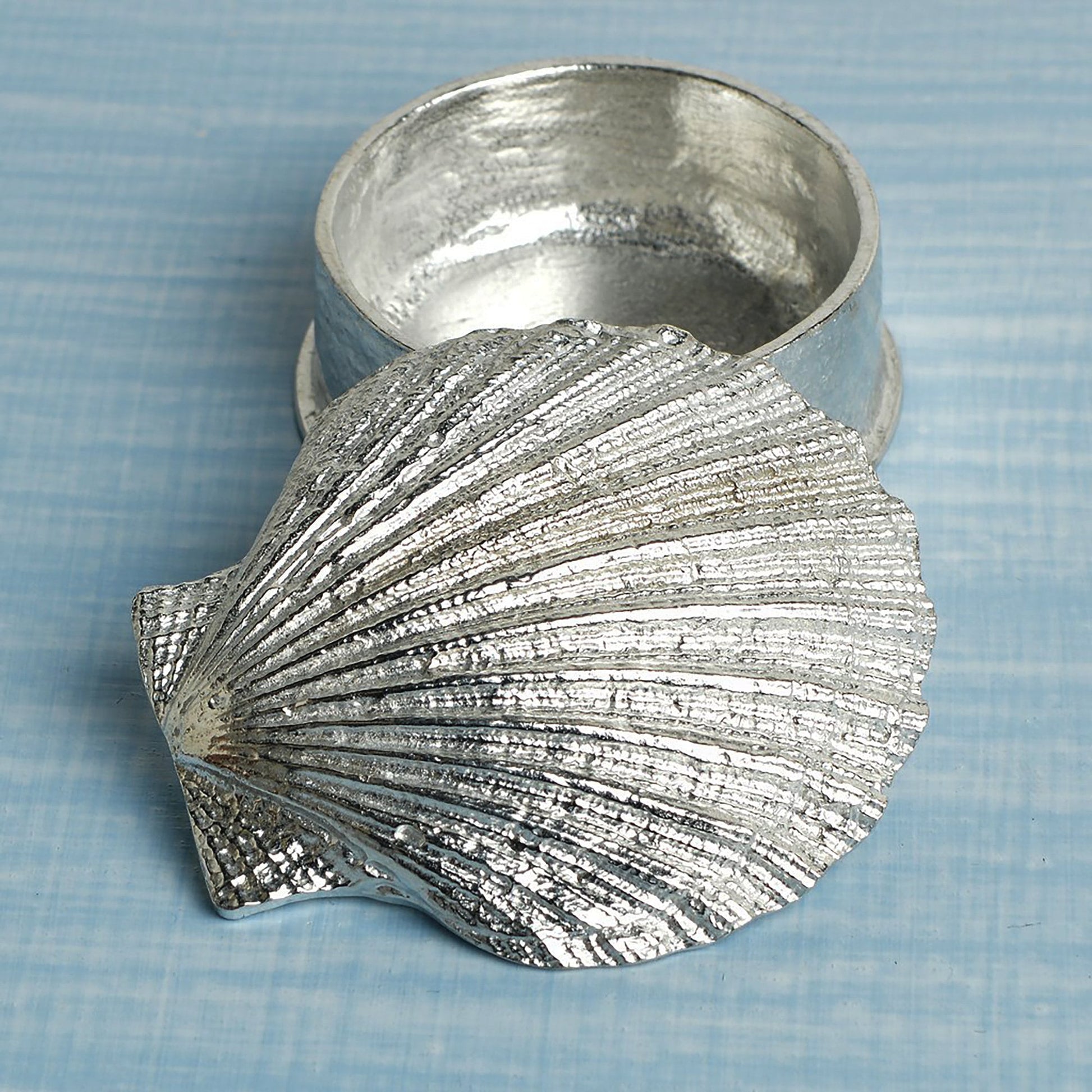 A round  pewter trinket box with a scallop shell lid. Nautical gifts for lovers of the seaside and sea life. 