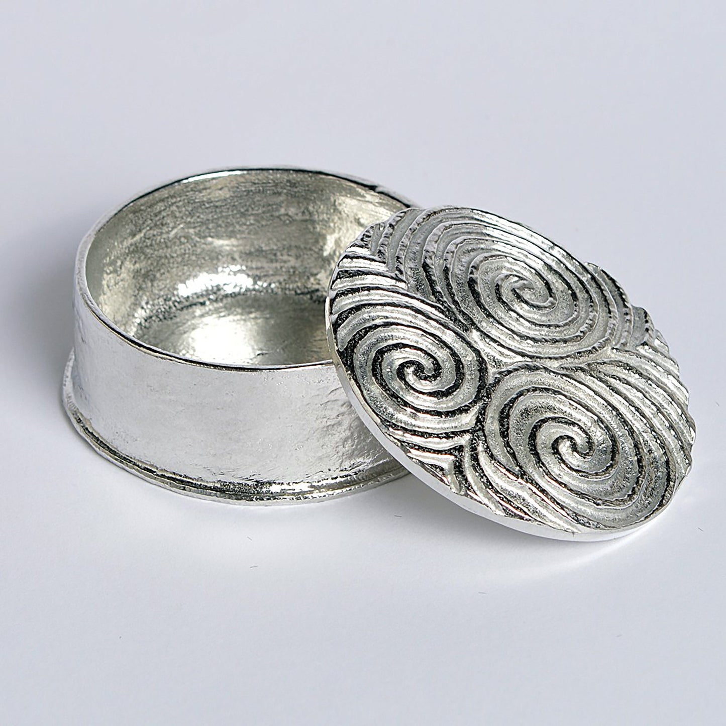 A detailed, striking and wonderfully textured Neolithic Spiral of Life Treskelion pewter trinket box. The lid features a relief of the spiral of life found in many Neolithic carvings. Celtic gifts.