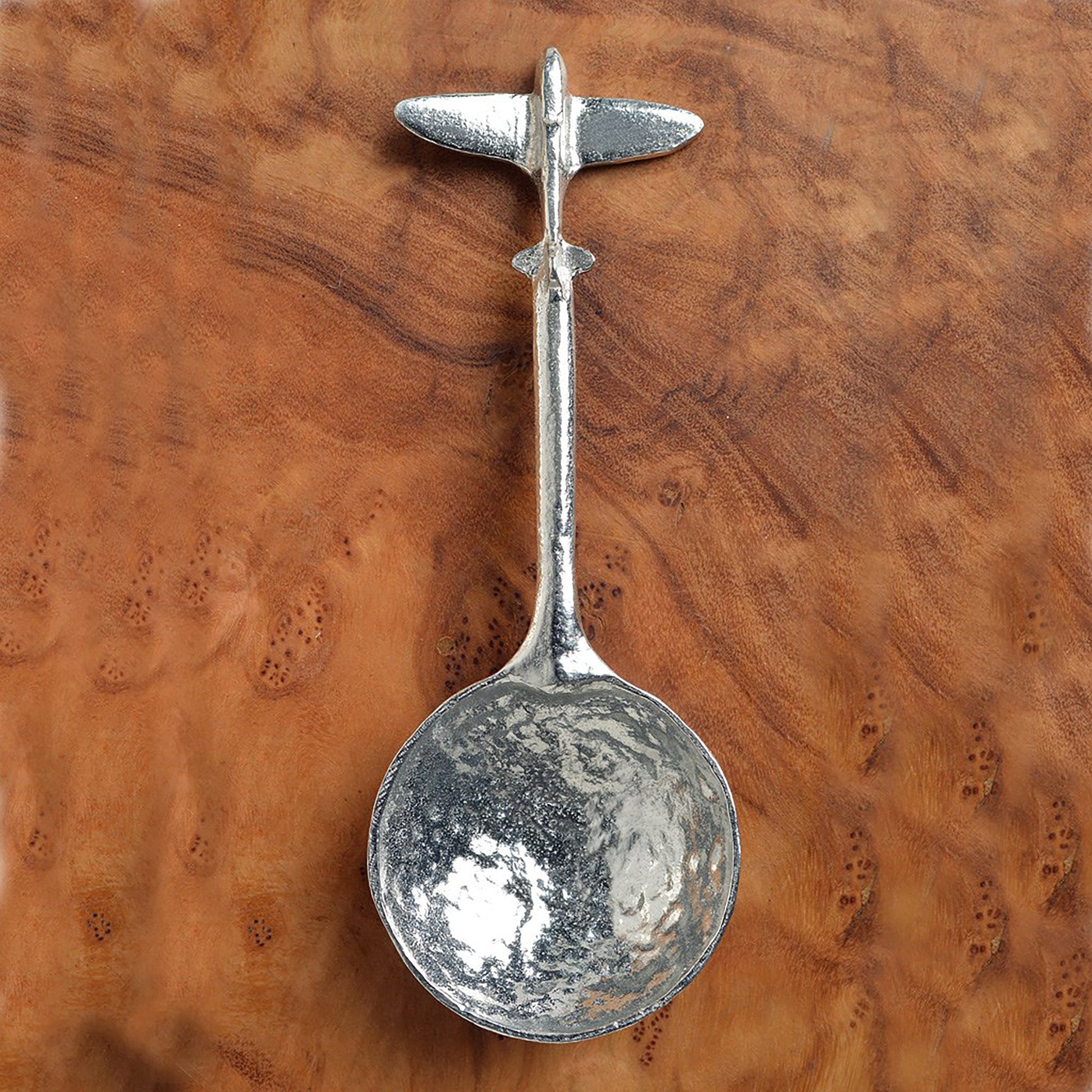 A small spoon pewter sugar spoon. A round bowled spoon on a straight handle leads to a perfectly sculpted spitfire aeroplane. Practical & useful spitfire gifts for spitfire lovers. UK handmade