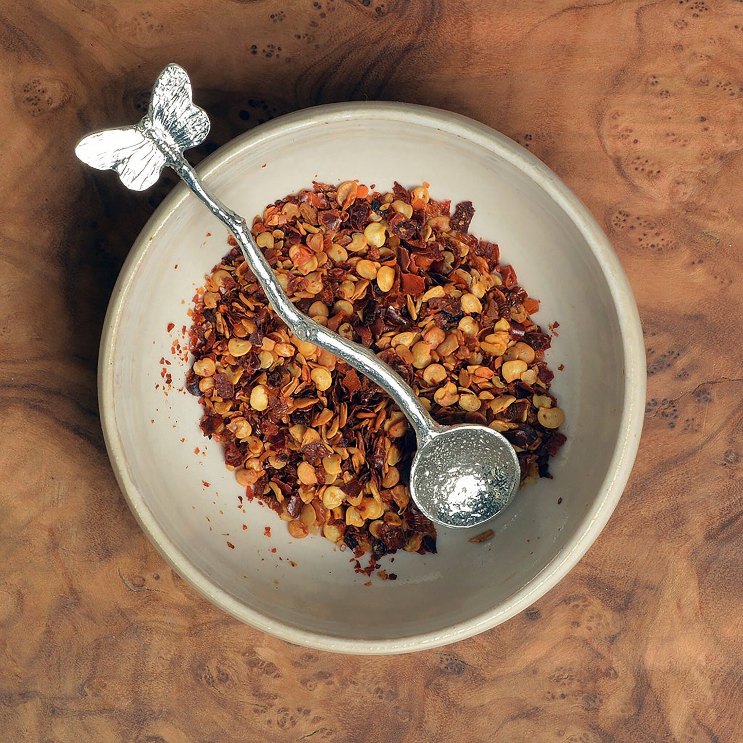 a tiny spice, salt or condiment spoon. Our pewter spoon has a small 10mm bowl leading up a fine twig textured handle to a small butterfly sculpture. Butterfly gifts for butterfly lovers