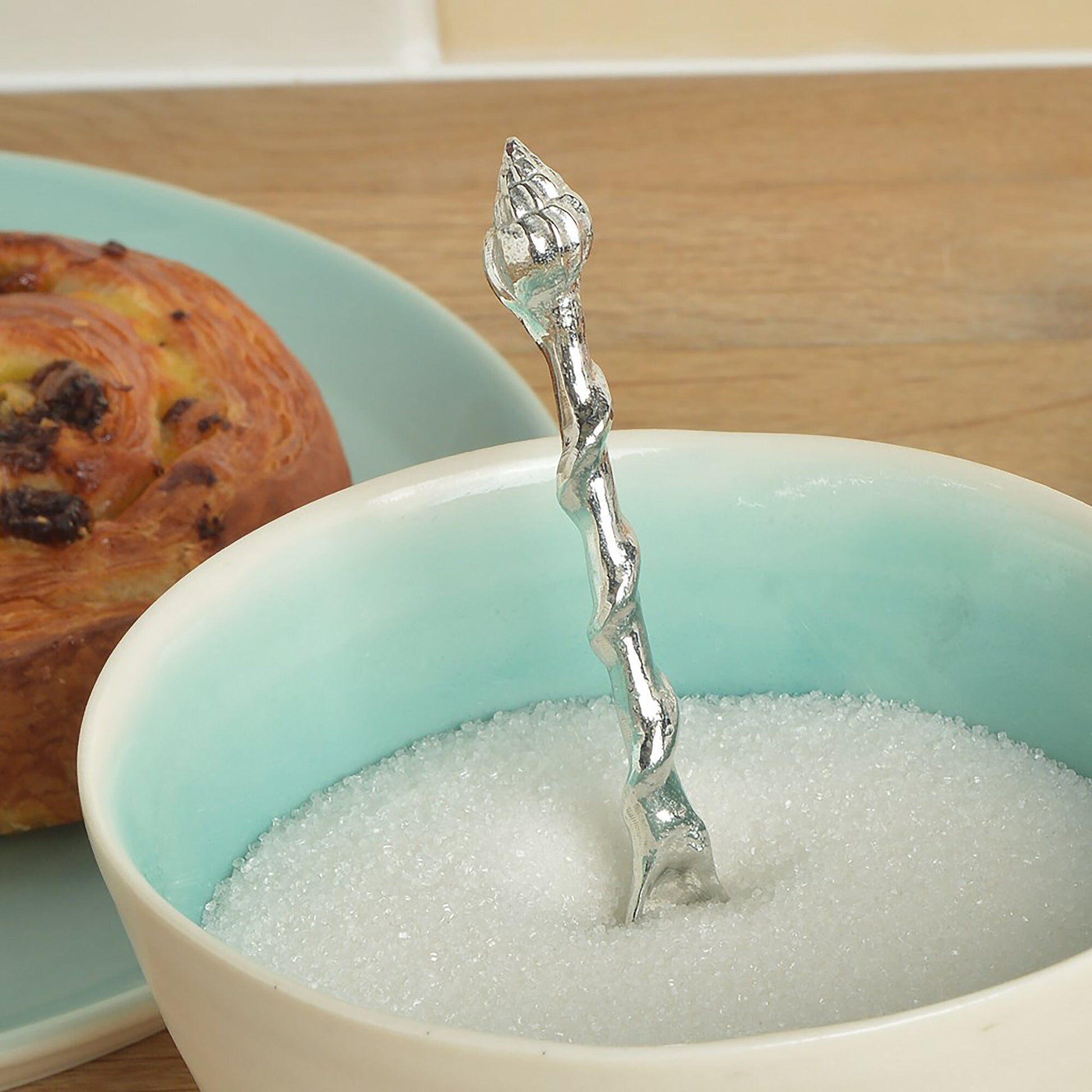 A small spoon pewter sugar spoon. A mussel shell provides the bowl with a twisted stem leading to a seashell. Practical & useful nautical gifts. UK handmade