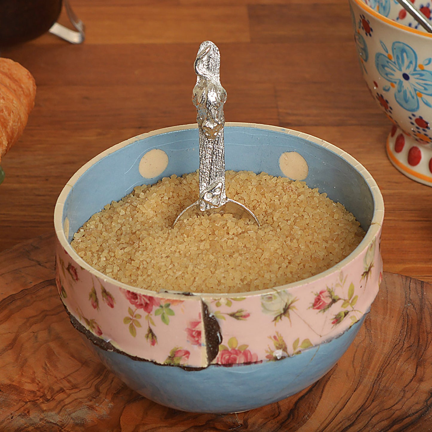 A small spoon pewter sugar spoon. A round bowled spoon leads to a wood textured stem with a mouse chasing a wedge of cheese. Practical & useful mouse gifts for nature lovers. UK handmade