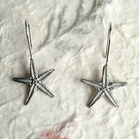 Starfish drop earrings, pewter starfishes on Sterling silver ear hooks. Pewter and silver starfish jewellery gifts, handmade in the UK by Glover and Smith