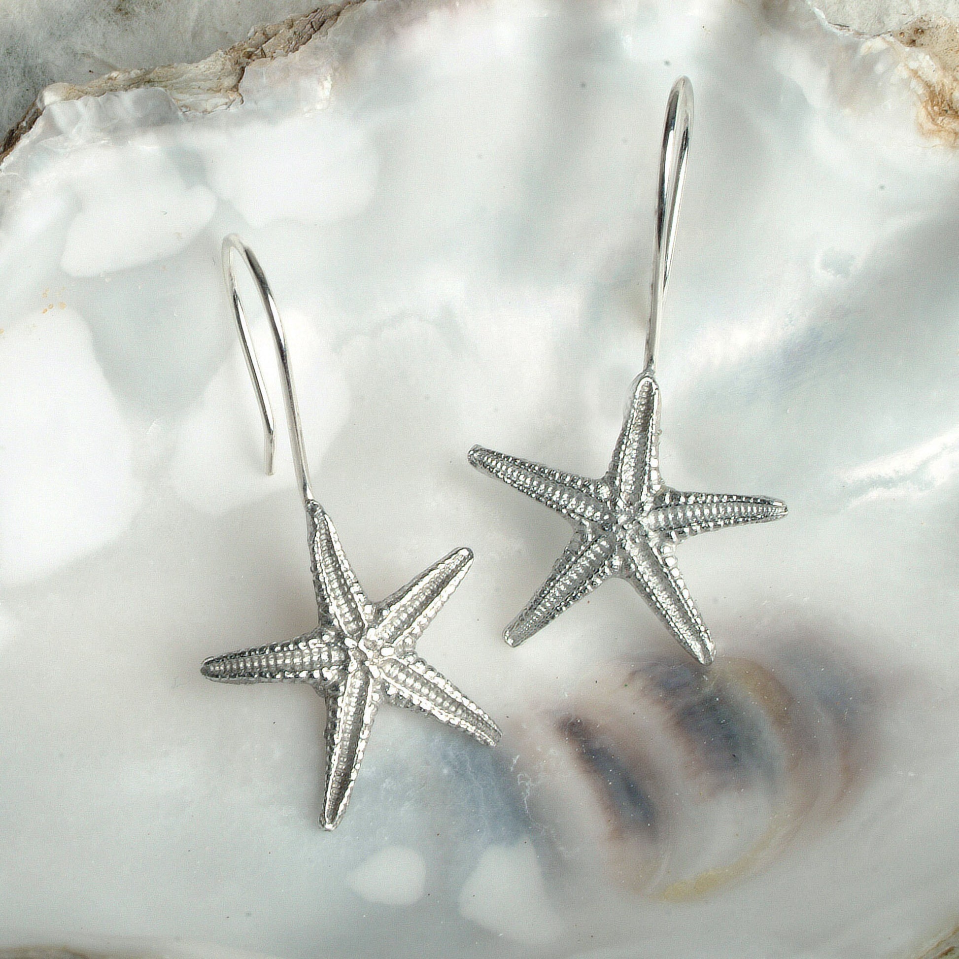 Starfish drop earrings, pewter starfishes on Sterling silver ear hooks. Pewter and silver starfish jewellery gifts, handmade in the UK by Glover and Smith