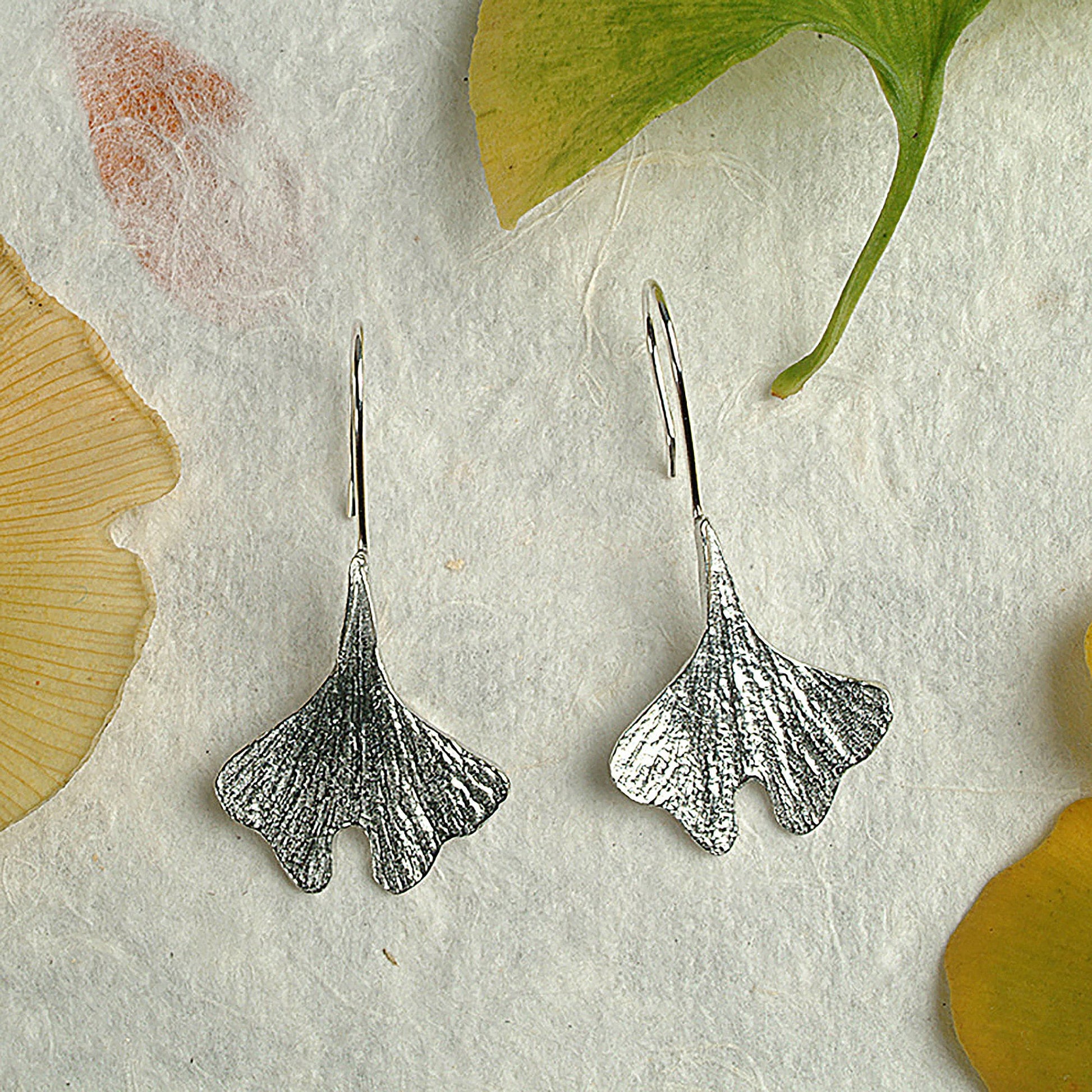 Ginkgo leaf drop earrings, pewter ginkgo leaves on Sterling silver ear hooks. Pewter and silver ginkgo leaf jewellery gifts, handmade in the UK by Glover and Smith