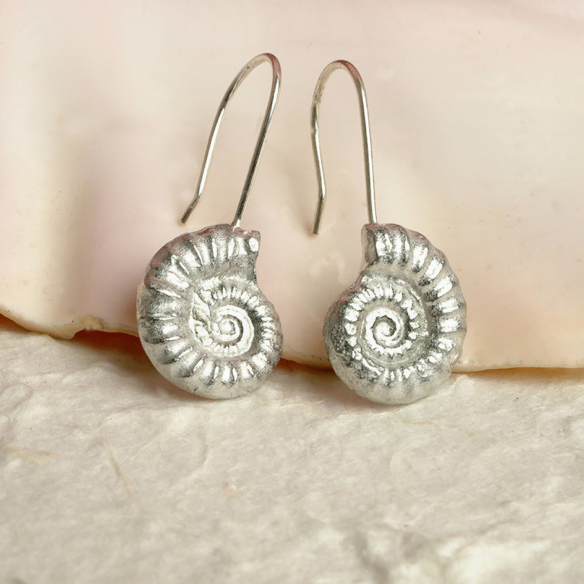 Ammonite drop earrings, pewter ammonite fossils on Sterling silver ear hooks. Pewter and silver ammonite jewellery gifts, handmade in the UK by Glover and Smith