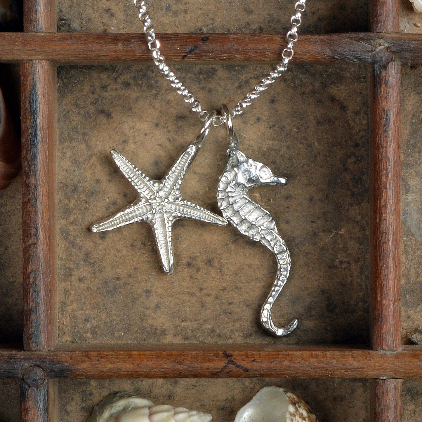 A delicate and detailed pewter seahorse and starfish necklace on an 18" Sterling silver chain. Great jewellery gifts for her, nautical gifts for starfish and seahorse lovers. The perfect 10th tin 10 year wedding anniversary gift (Our pewter is 95% tin). Made in Britain with love. 