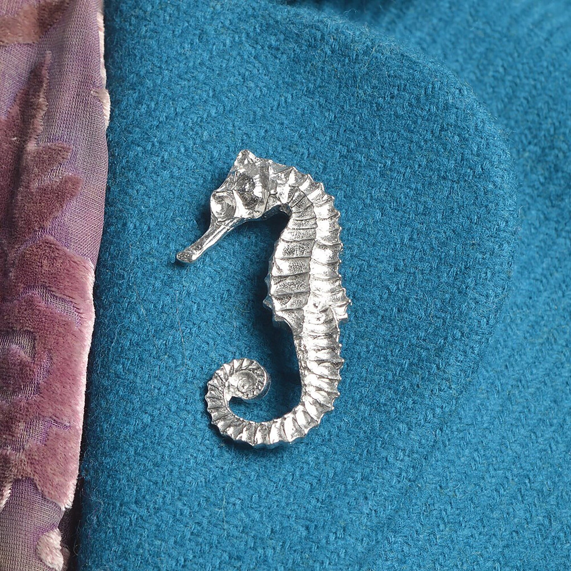 An eye catching and beautifully detailed seahorse pewter brooch. Great nautical seahorse gifts for lovers of the seaside and the ocean. Each seahorse brooch is 5.5cm (2.2 inches) tall and is attached with a metal clasp pin.