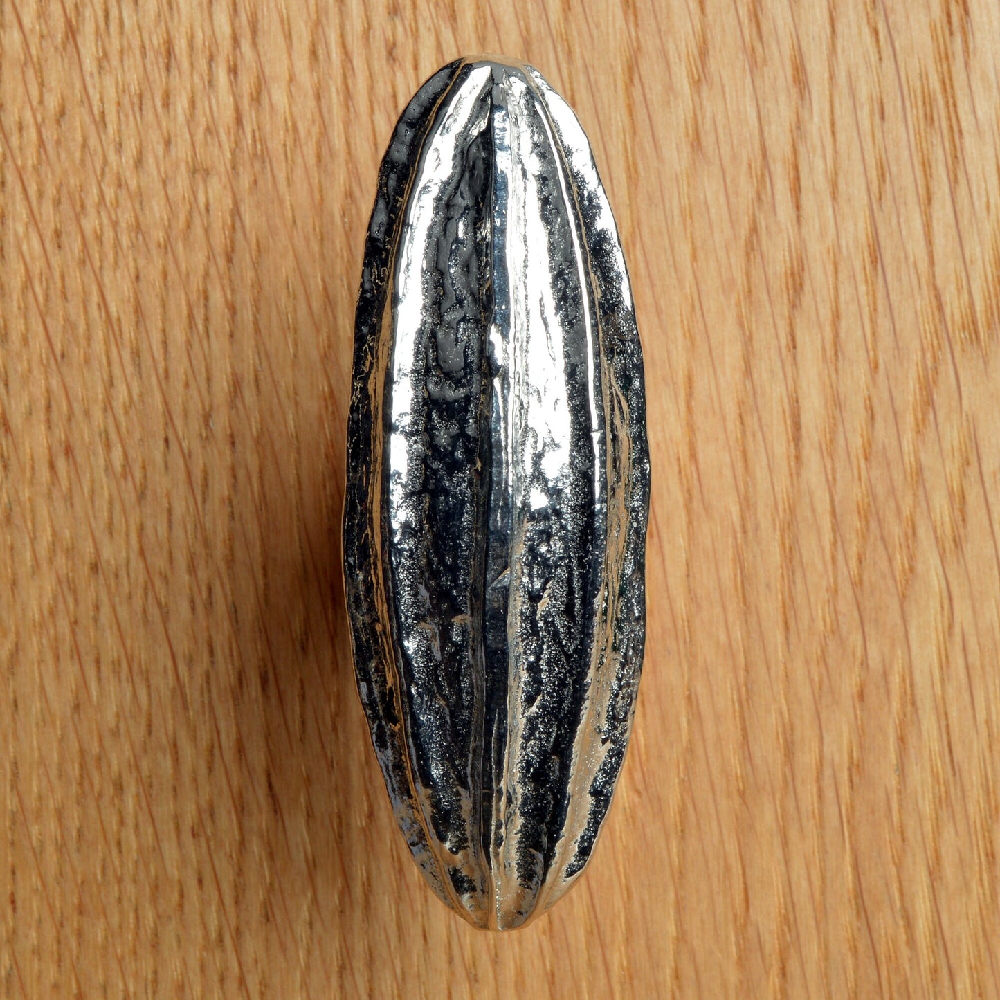 A solid pewter cabinet handle, cupboard knob, furniture handle or drawer pull in the shape of a detailed generic seed pod. Organic, unusual handles UK handmade with finesse