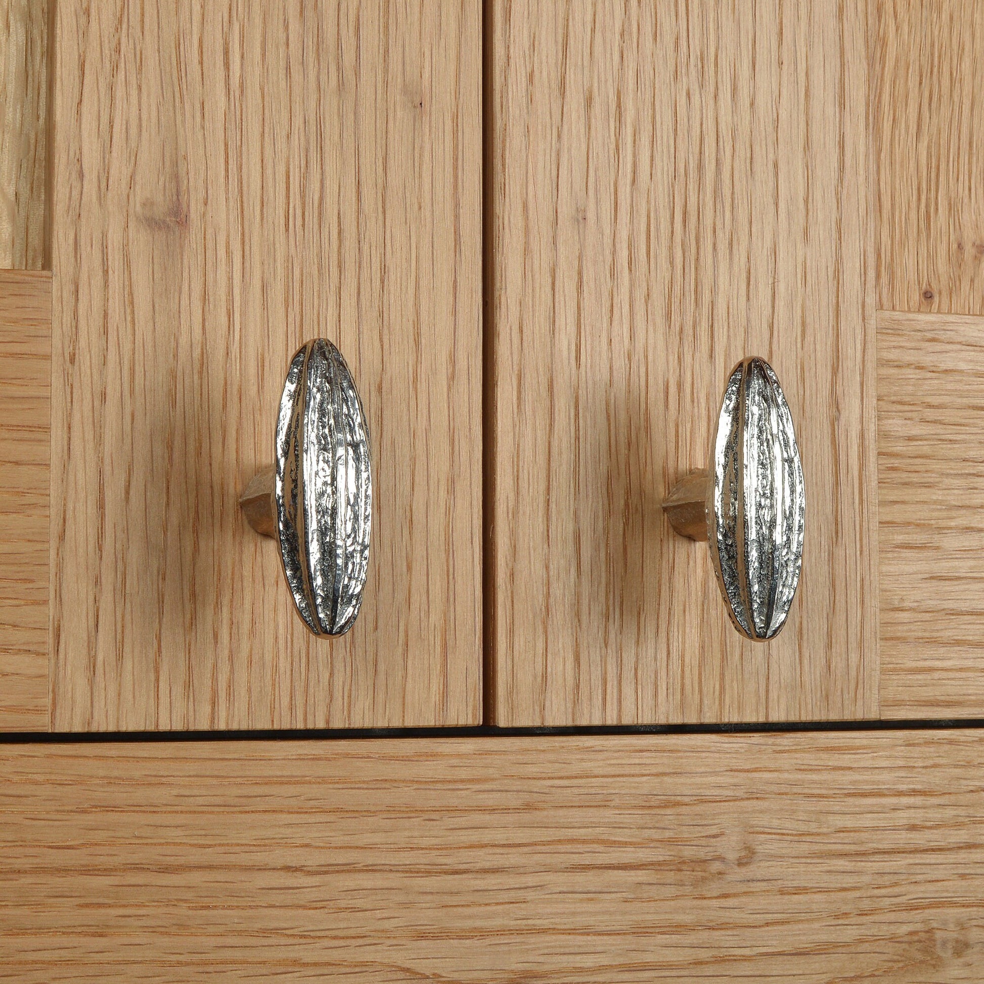 A solid pewter cabinet handle, cupboard knob, furniture handle or drawer pull in the shape of a detailed generic seed pod. Organic, unusual handles UK handmade with finesse