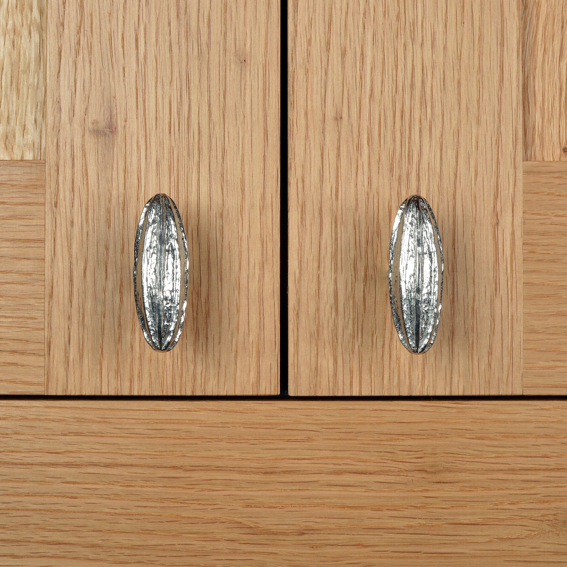 A solid pewter cabinet handle, cupboard knob, furniture handle or drawer pull in the shape of a detailed generic seed pod. Organic, unusual handles UK handmade with finesse