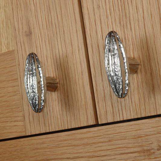 A solid pewter cabinet handle, cupboard knob, furniture handle or drawer pull in the shape of a detailed generic seed pod. Organic, unusual handles UK handmade with finesse