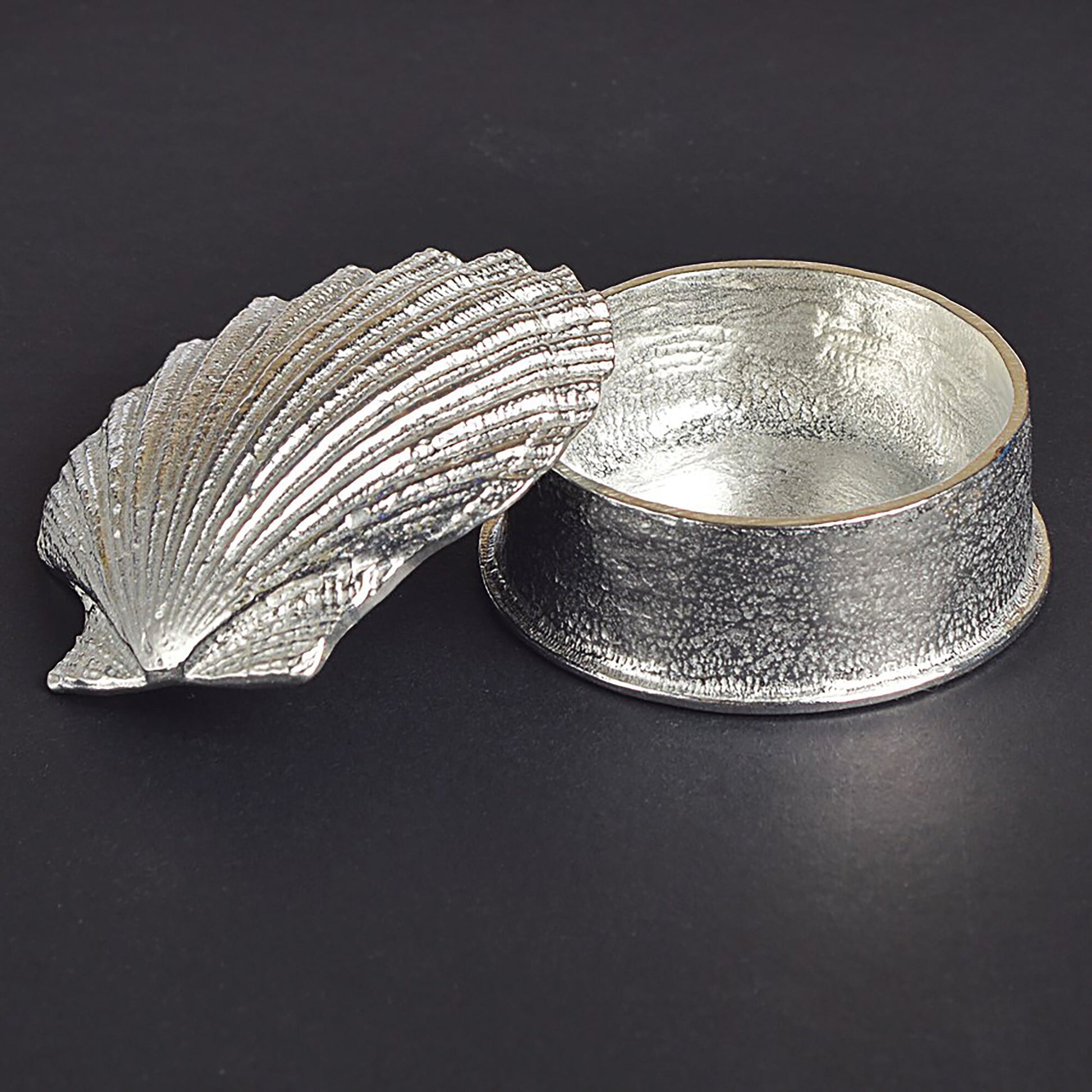 A round  pewter trinket box with a scallop shell lid. Nautical gifts for lovers of the seaside and sea life. 