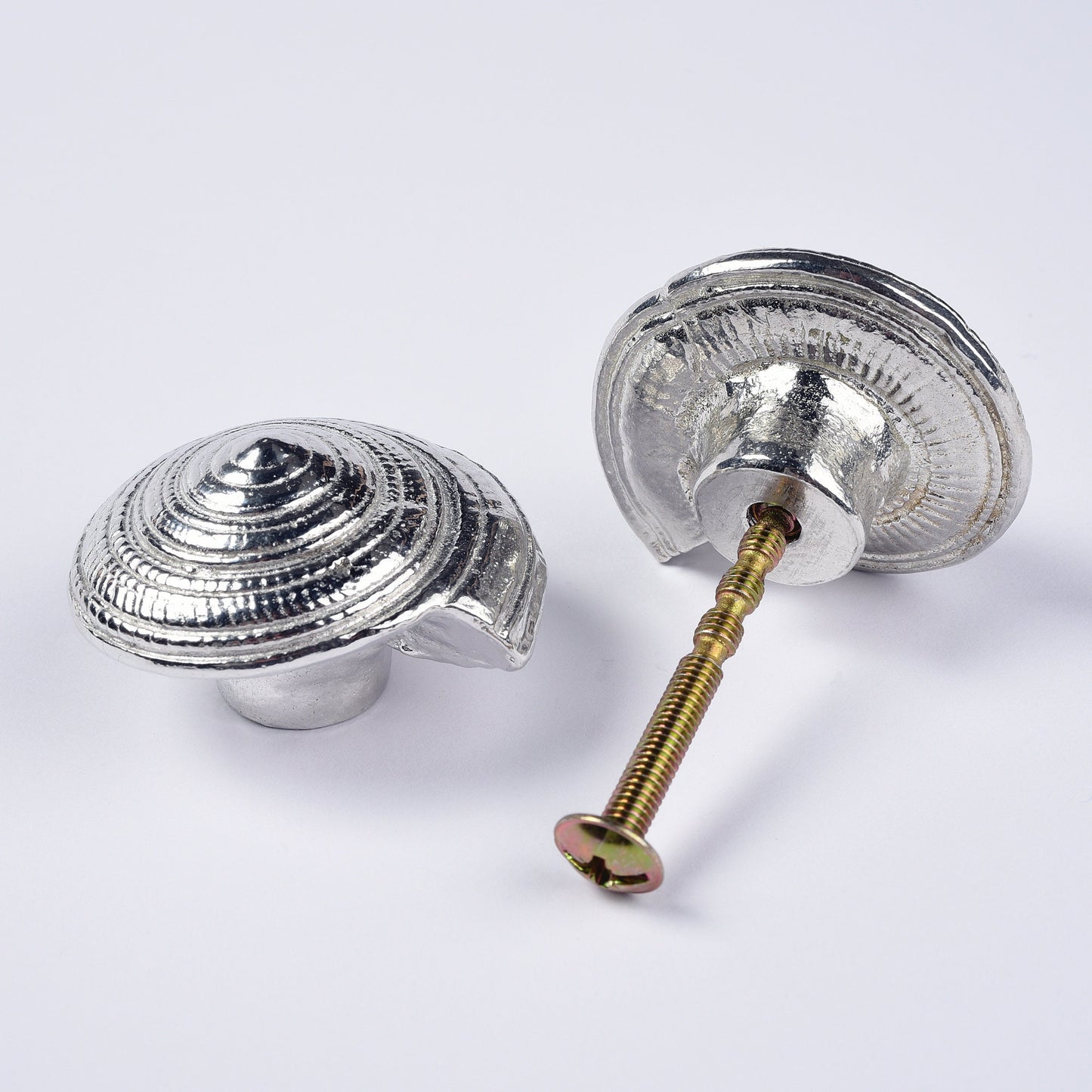 A solid pewter cabinet handle, cupboard knob, furniture handle or drawer pull in the shape of a detailed spiral sea shell. Organic, unusual handles UK handmade with finesse