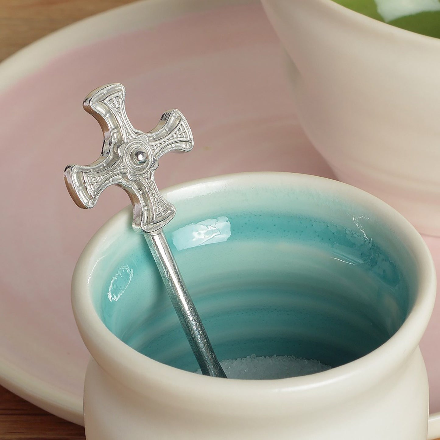 A small spoon pewter sugar spoon with Durham cathedral's St Cuthbert Cross on the end of a straight handle. Christening gifts for boys and girls