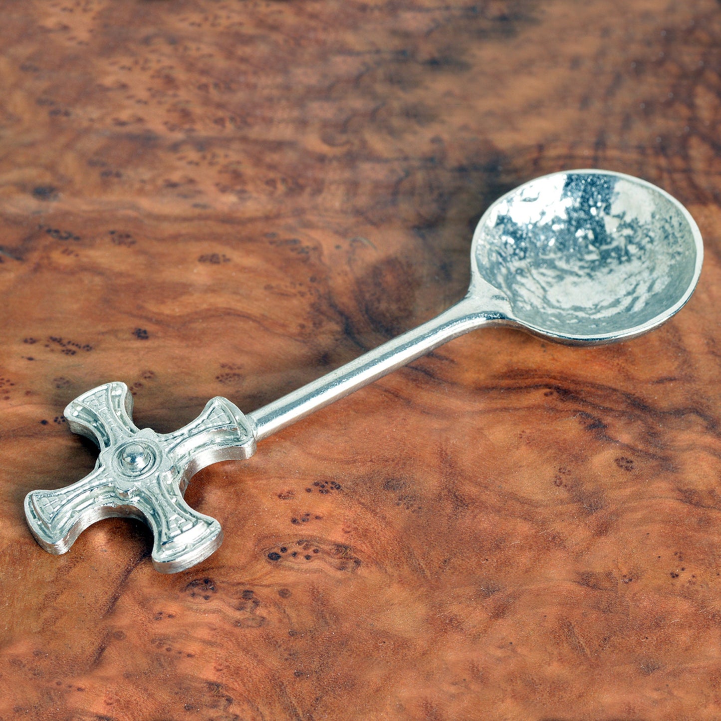 A small spoon pewter sugar spoon with Durham cathedral's St Cuthbert Cross on the end of a straight handle. Christening gifts for boys and girls