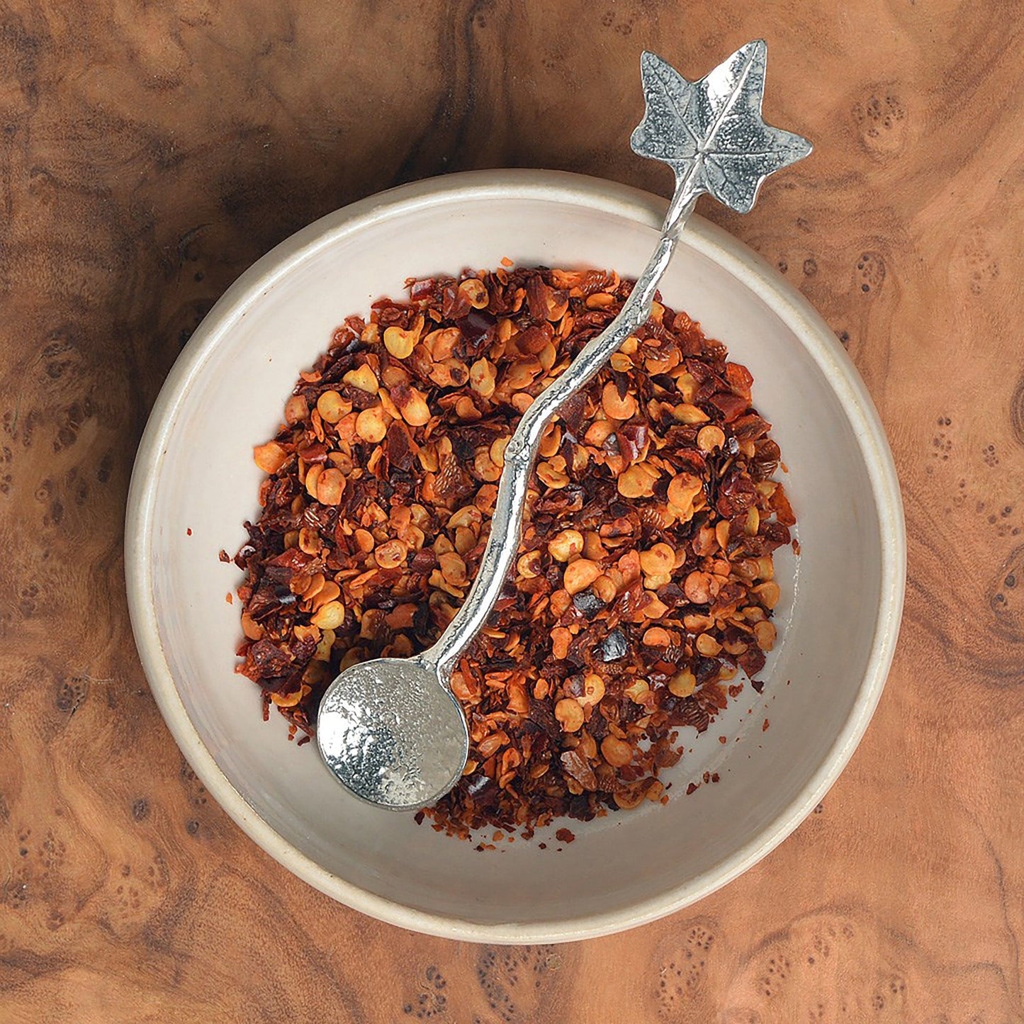 a tiny spice, salt or condiment spoon. Our pewter spoon has a small 10mm bowl leading up a fine twig textured handle to a small ivy leaf. Gifts for nature lovers.