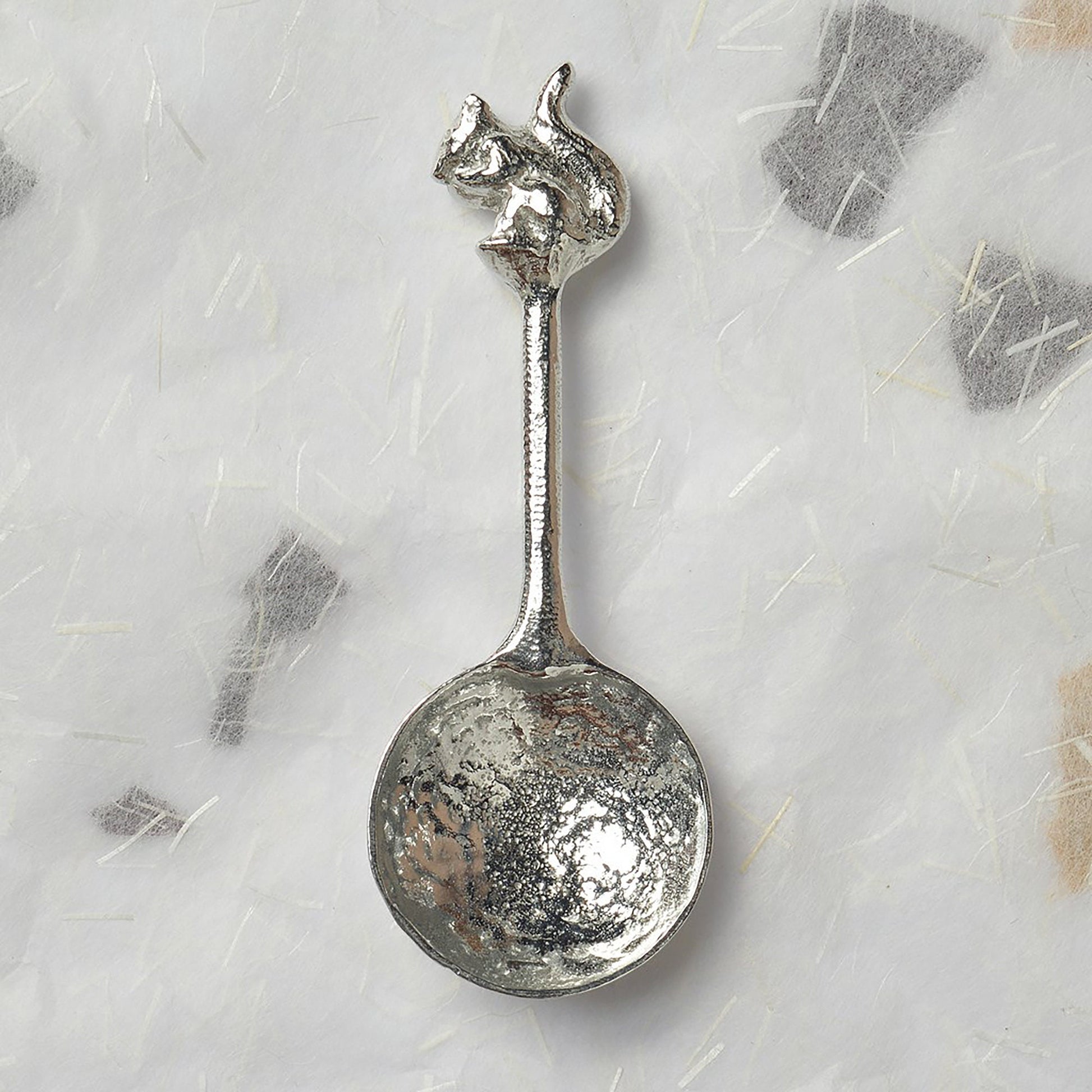 A small spoon pewter sugar spoon. A round bowled spoon on a straight handle leads to a perfectly sculpted squirrel. Practical & useful squirrel gifts for nature lovers. UK handmade