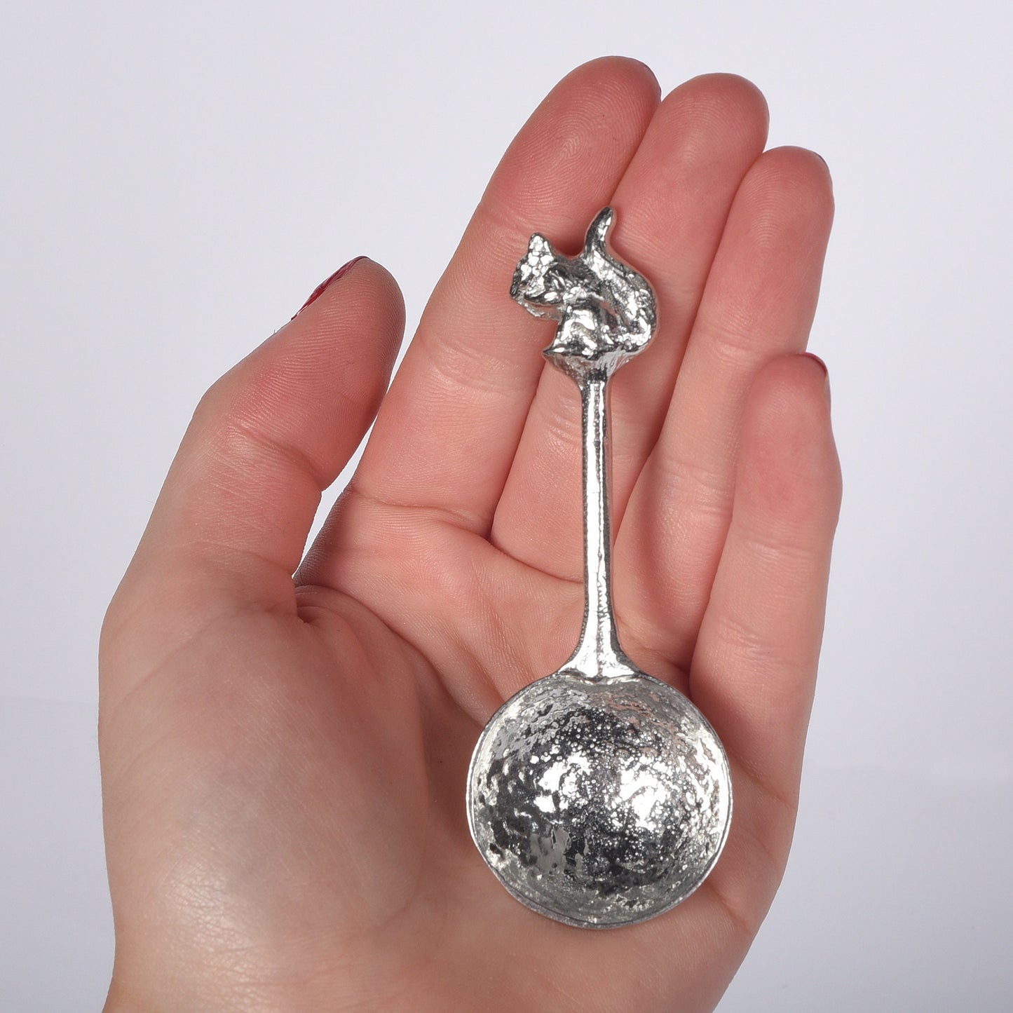 A small spoon pewter sugar spoon. A round bowled spoon on a straight handle leads to a perfectly sculpted squirrel. Practical & useful squirrel gifts for nature lovers. UK handmade