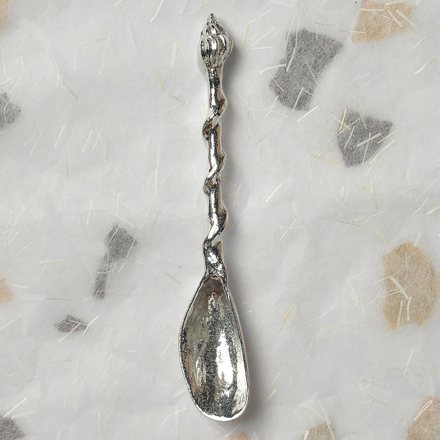 A small spoon pewter sugar spoon. A mussel shell provides the bowl with a twisted stem leading to a seashell. Practical & useful nautical gifts. UK handmade