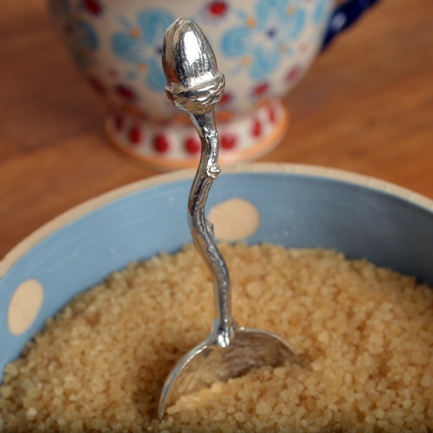 A small spoon pewter sugar spoon with an acorn on the end of a twig handle. Unusual, useful and tactile little acorn gifts  handmade in the UK