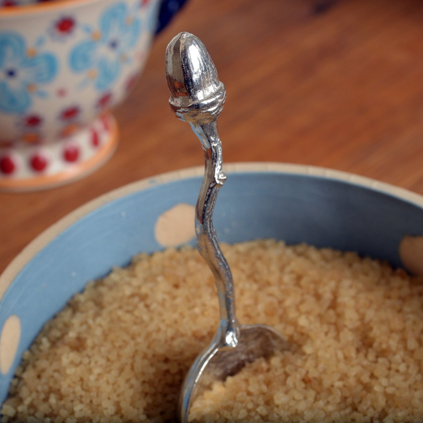 A small spoon pewter sugar spoon with an acorn on the end of a twig handle. Unusual, useful and tactile little acorn gifts  handmade in the UK