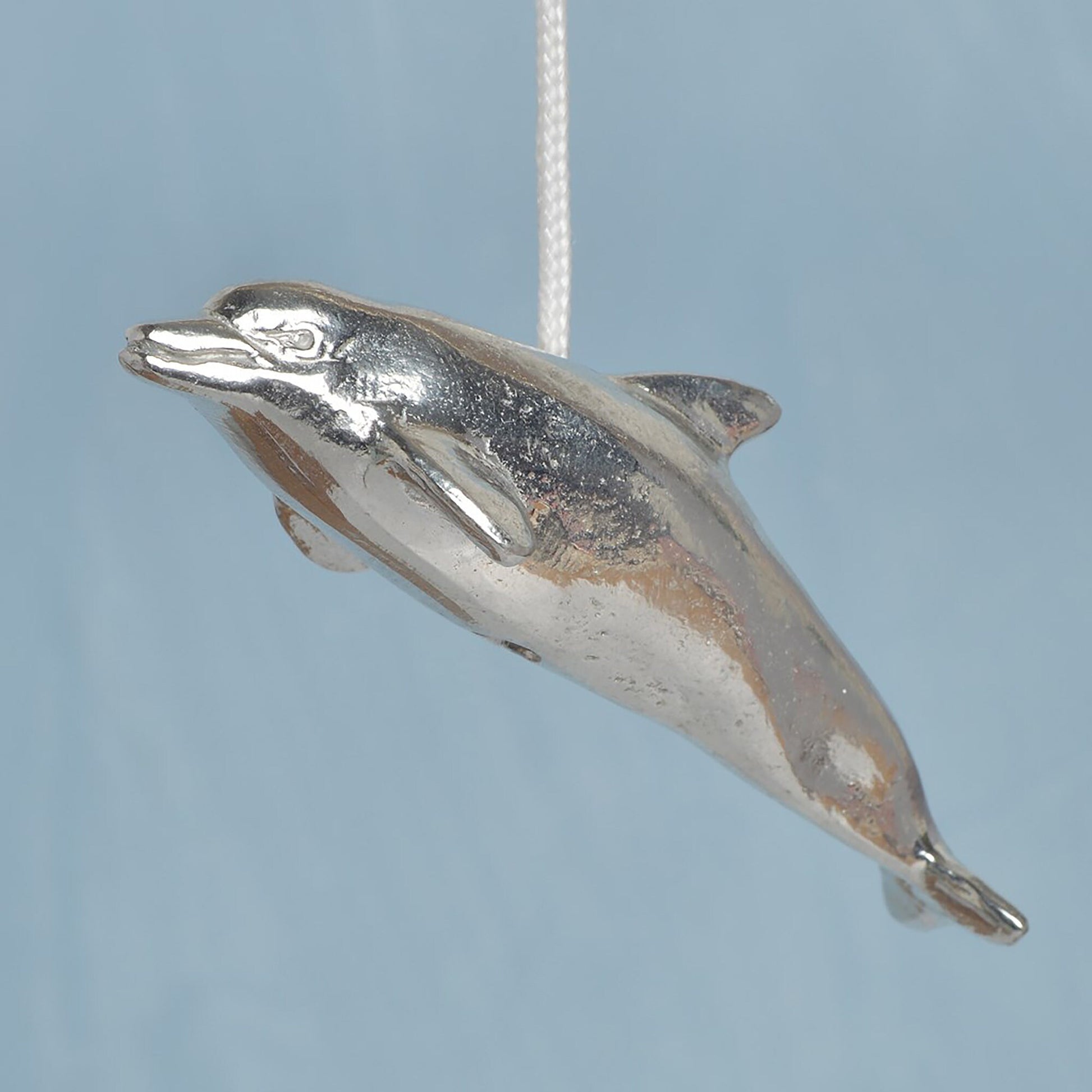 Dolphin bathroom light pull or cord pull. A tactile and decorative pewter dolphin hangs at the bottom of the bathroom light switch cord. ideal little housewarming gifts. Dolphin gifts.