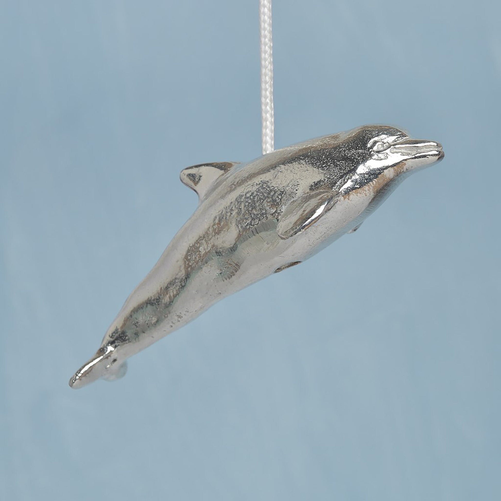 Dolphin bathroom light pull or cord pull. A tactile and decorative pewter dolphin hangs at the bottom of the bathroom light switch cord. ideal little housewarming gifts. Dolphin gifts.