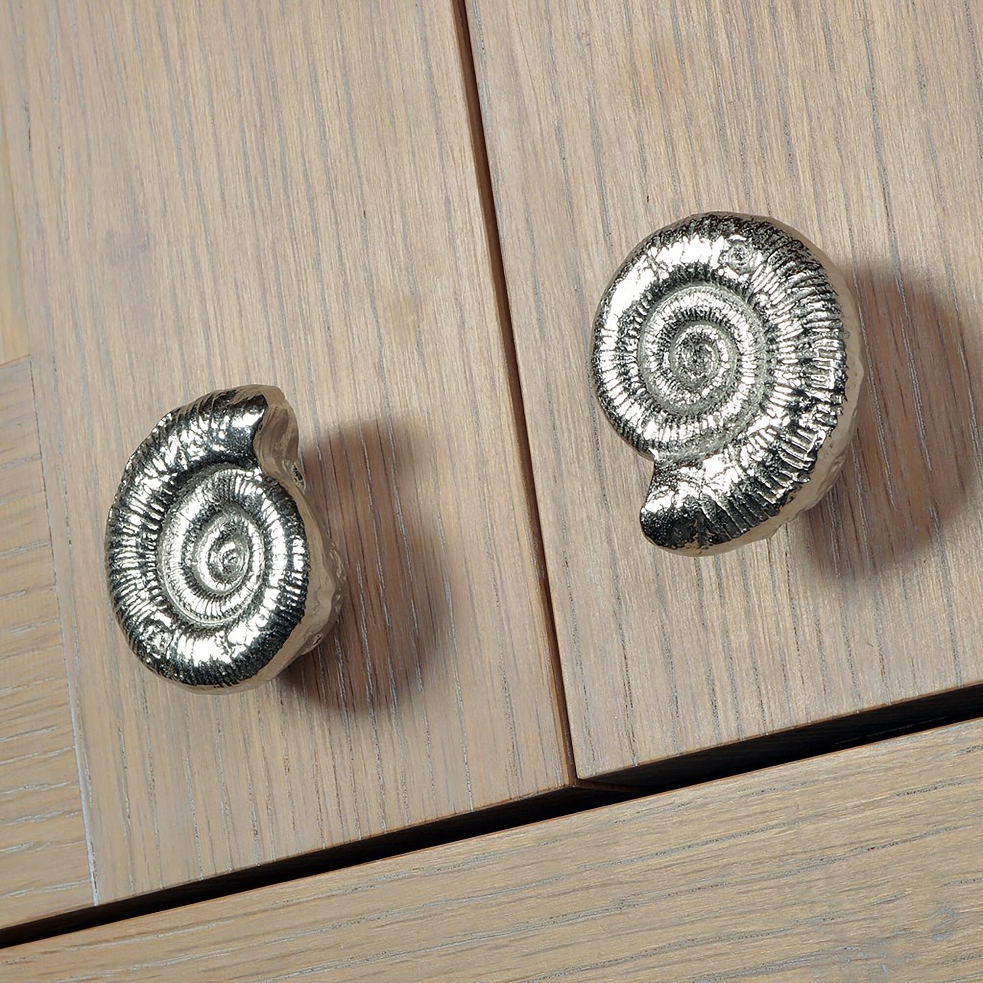 A solid pewter cabinet handle, cupboard knob, furniture handle or drawer pull in the shape of a detailed ammonite fossil. Organic, unusual handles UK handmade with finesse