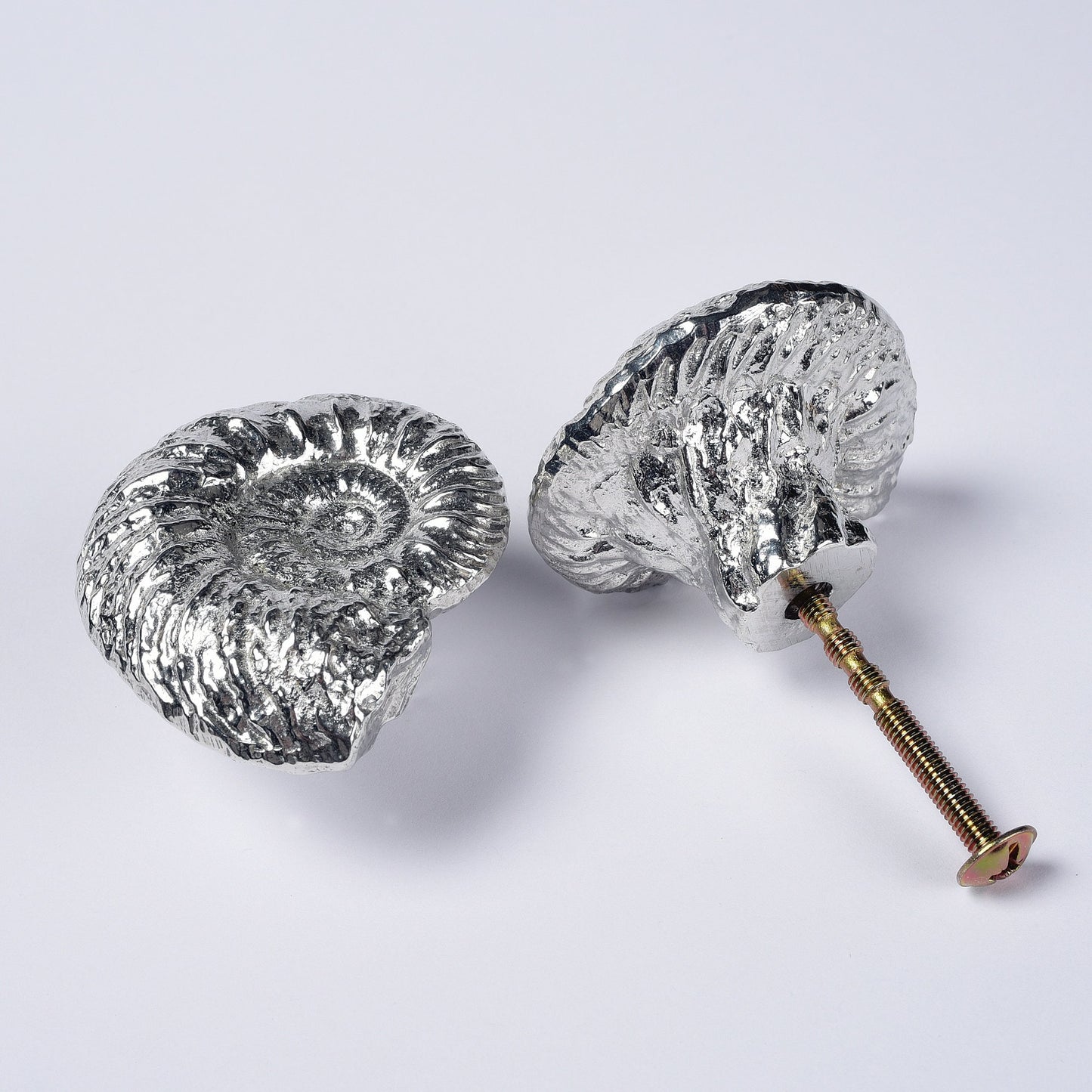 A solid pewter cabinet handle, cupboard knob, furniture handle or drawer pull in the shape of a detailed ammonite fossil. Organic, unusual handles UK handmade with finesse