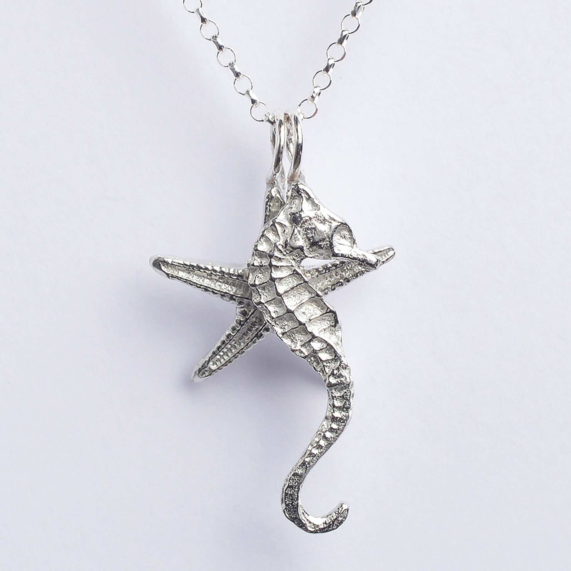 A delicate and detailed pewter seahorse and starfish necklace on an 18" Sterling silver chain. Great jewellery gifts for her, nautical gifts for starfish and seahorse lovers. The perfect 10th tin 10 year wedding anniversary gift (Our pewter is 95% tin). Made in Britain with love. 