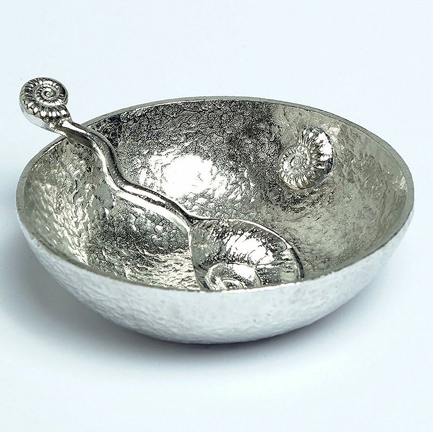 A 9cm diameter beautifully textured circular pewter bowl, with a striking, yet subtle ammonite fossil on the inside of the dish, comes with accompanying ammonite  fossil spoon. Gifts For Fossil Lovers